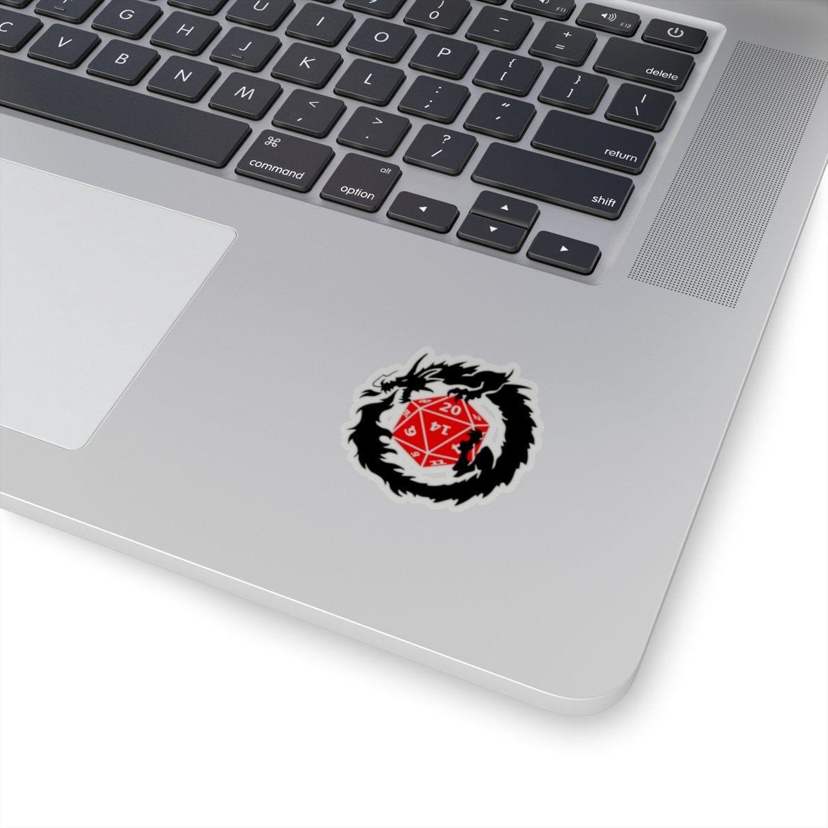 "Clutches of Fate D20 DND Dragon Dice Sticker on laptop, featuring a black dragon encircling a red D20, 2x2 inches, transparent background."