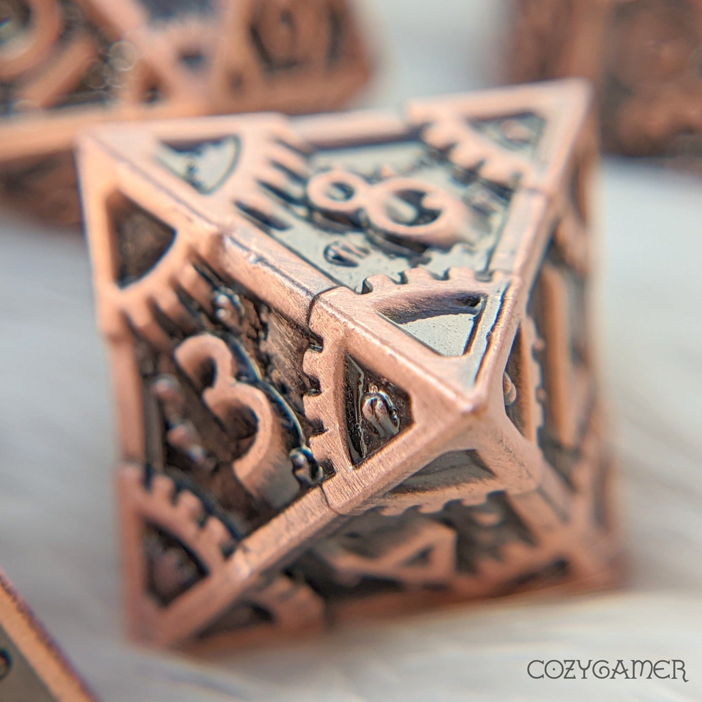 Copper metal gear dice with clockwork design, perfect for Dungeons and Dragons and tabletop RPGs, close-up view.