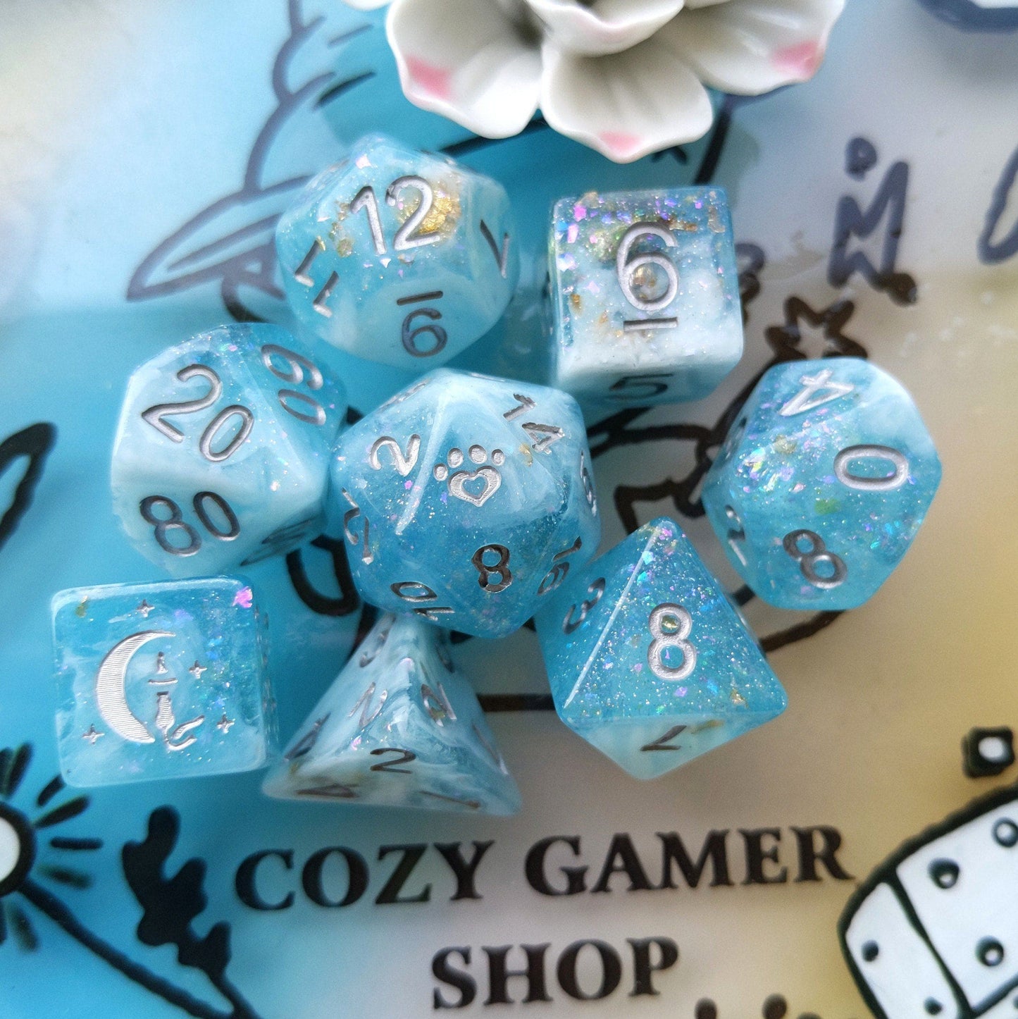 Cresting Wave DnD Dice Set with glitter flakes, featuring custom cat wizard, star, and paw designs for tabletop RPGs.