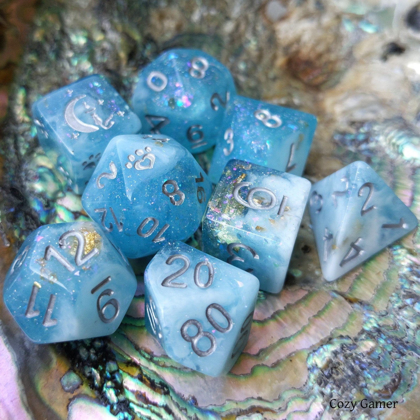Cresting Wave 8 Piece DnD Dice Set in clear blue with glitter, featuring cat wizard and paw designs, perfect for tabletop RPGs.