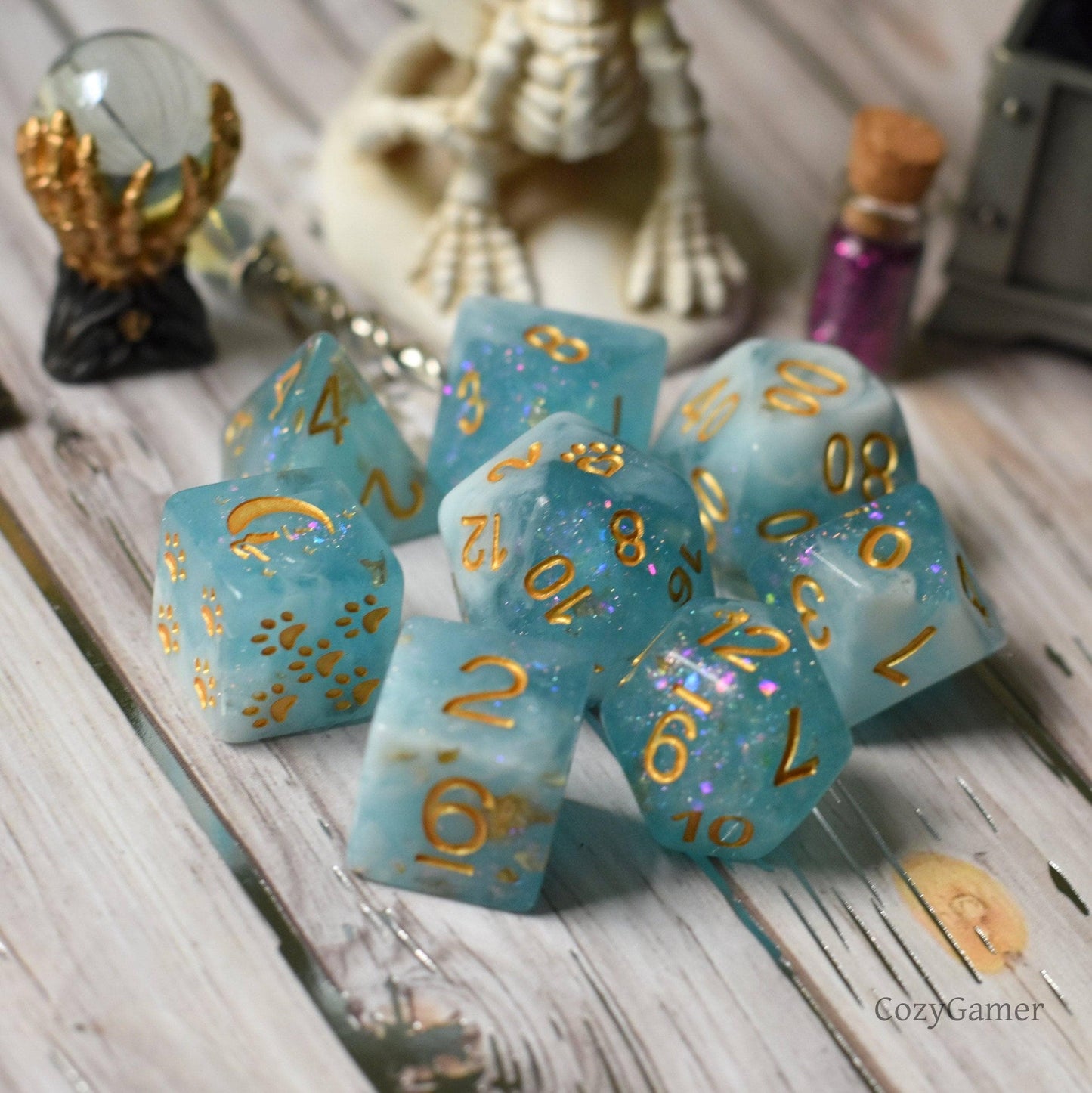 "Cresting Wave 8 Piece DnD Dice Set in clear blue resin with glitter and foil, featuring custom cat wizard and paw designs"