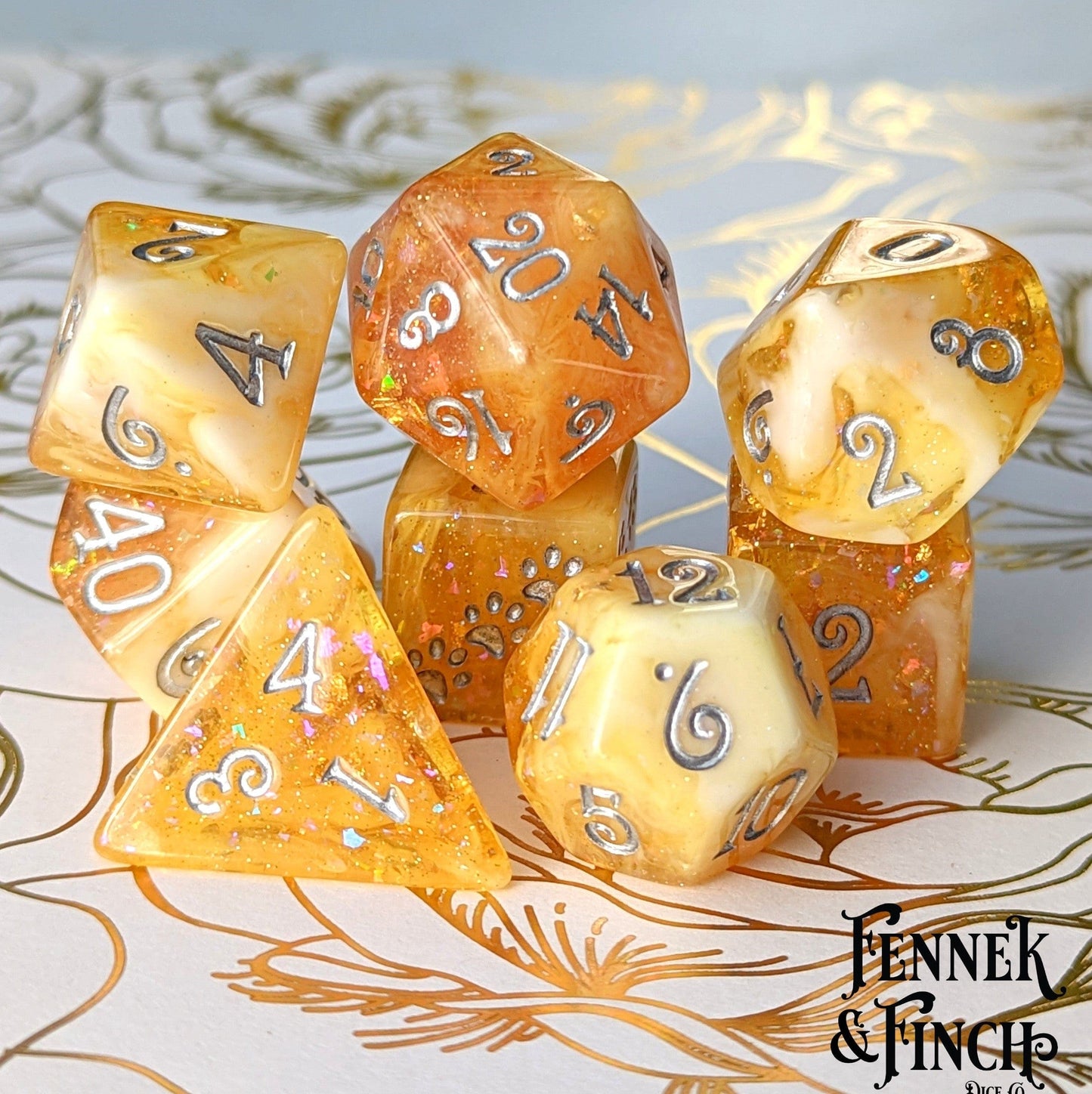 Crystallized Honey Dice Set with clear orange and white marble design, glitter, foil, and custom font for tabletop RPGs.
