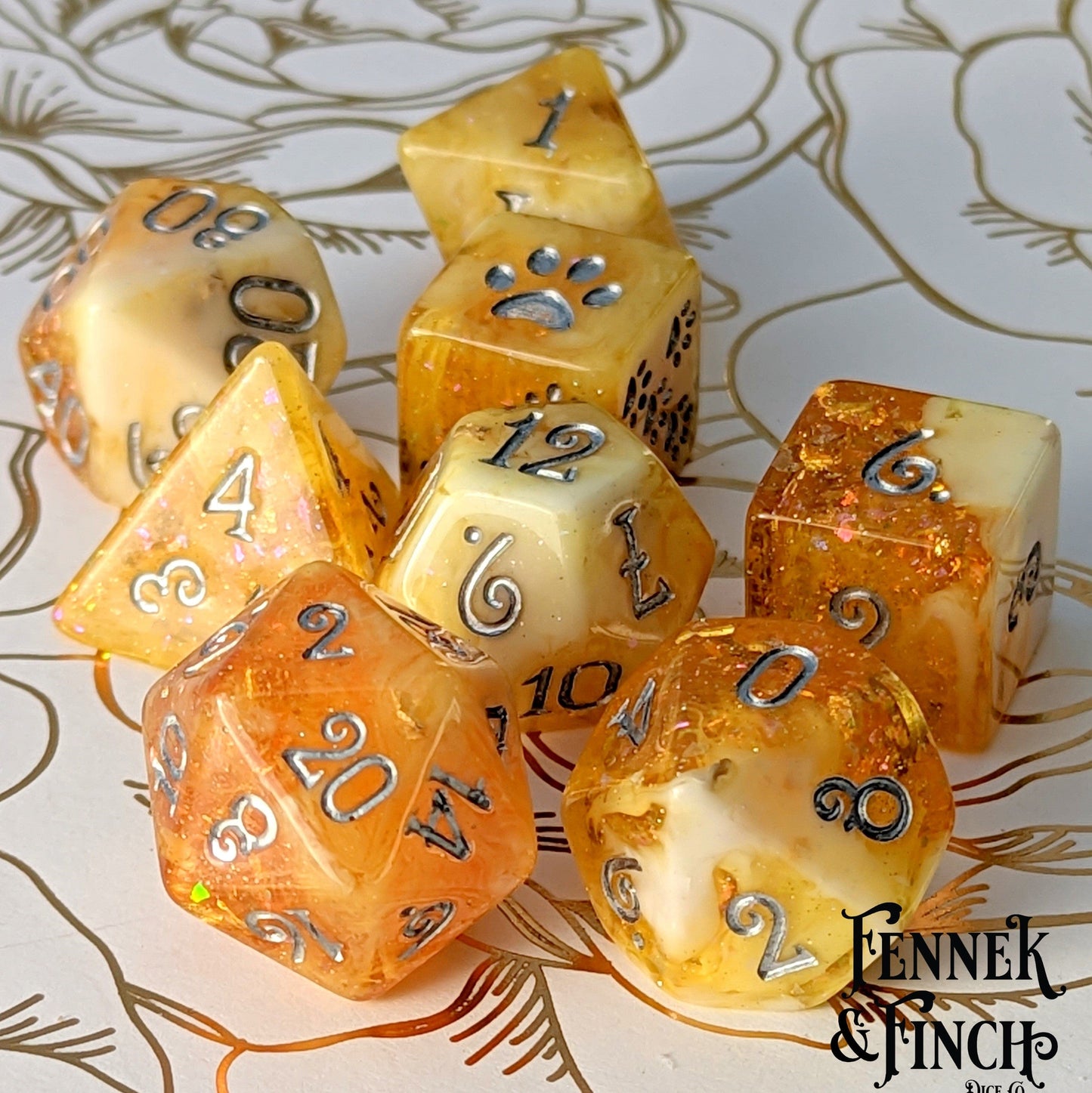 Crystallized Honey Dice Set in clear orange and white marble with glitter and foil accents, designed for Dungeons and Dragons.