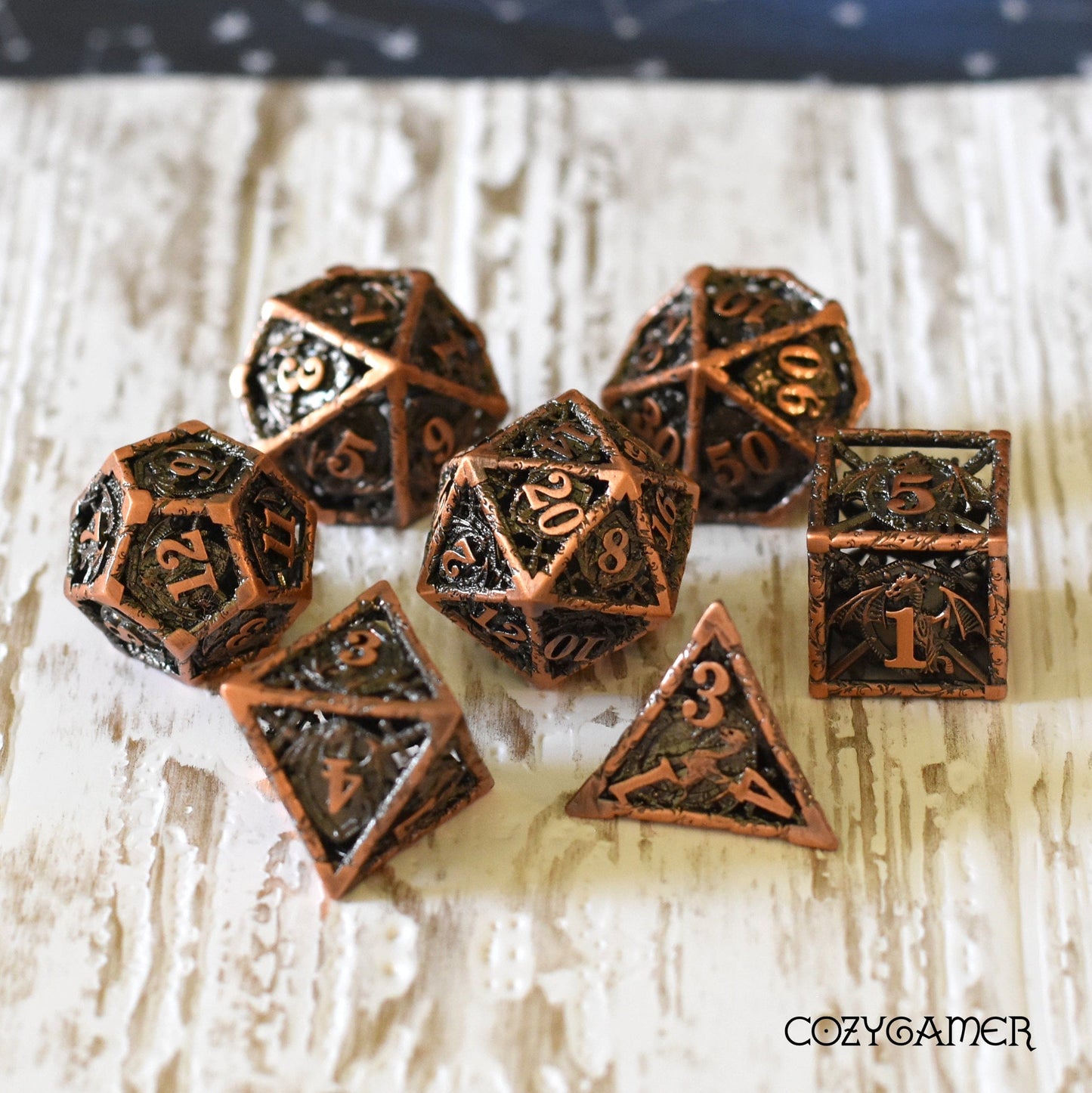 Dragon and Shield hollow metal dice set on wooden table, featuring intricate design and ideal for tabletop RPGs like Dungeons and Dragons.
