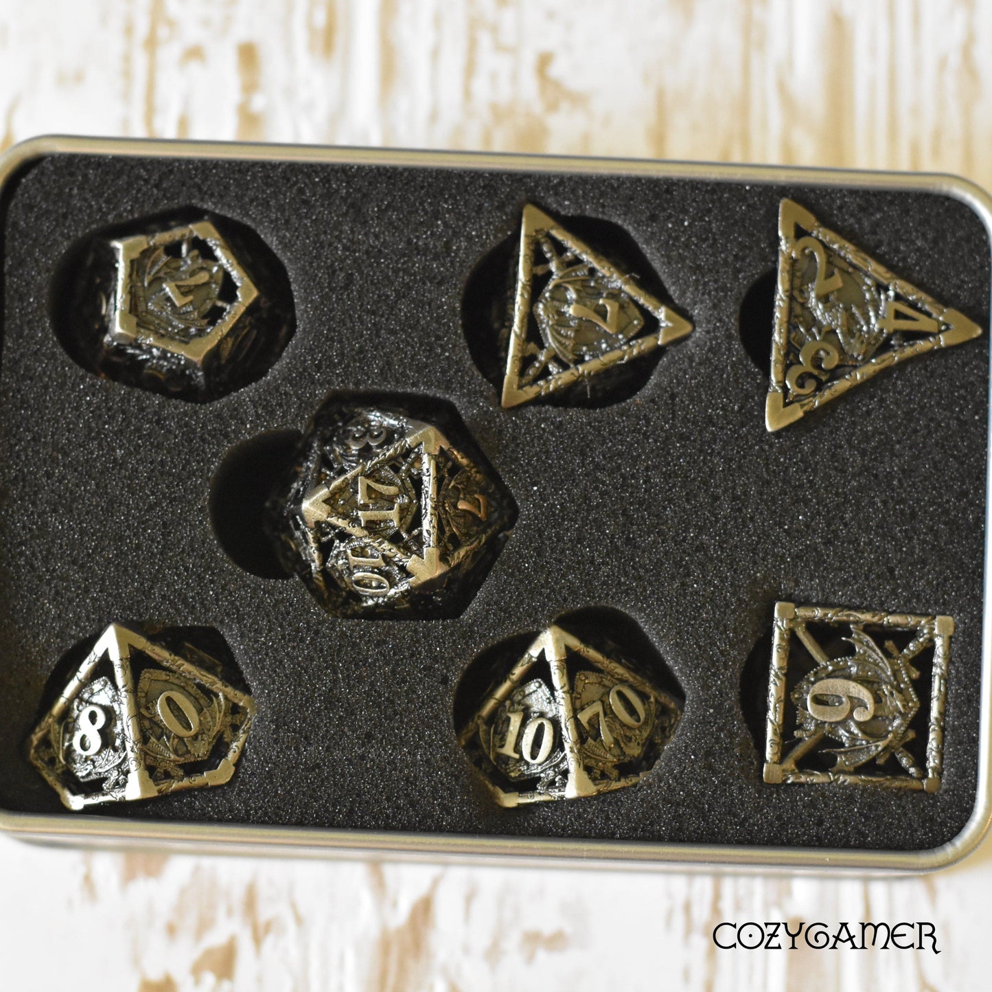 Dragon and Shield Hollow Metal Dice Set for tabletop games in black foam case.
