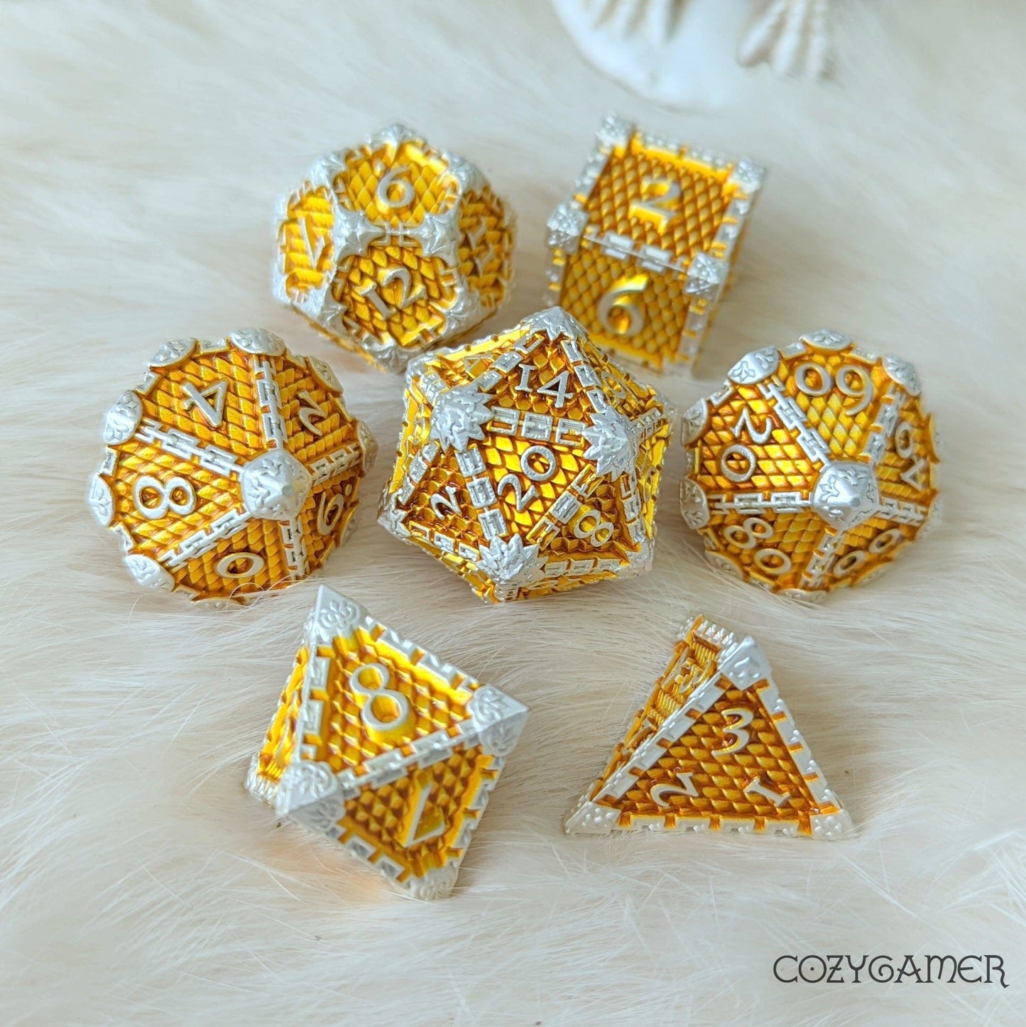 Dragon Scale Metal Dice Set in Silver and Gold on white background for DnD and tabletop games.