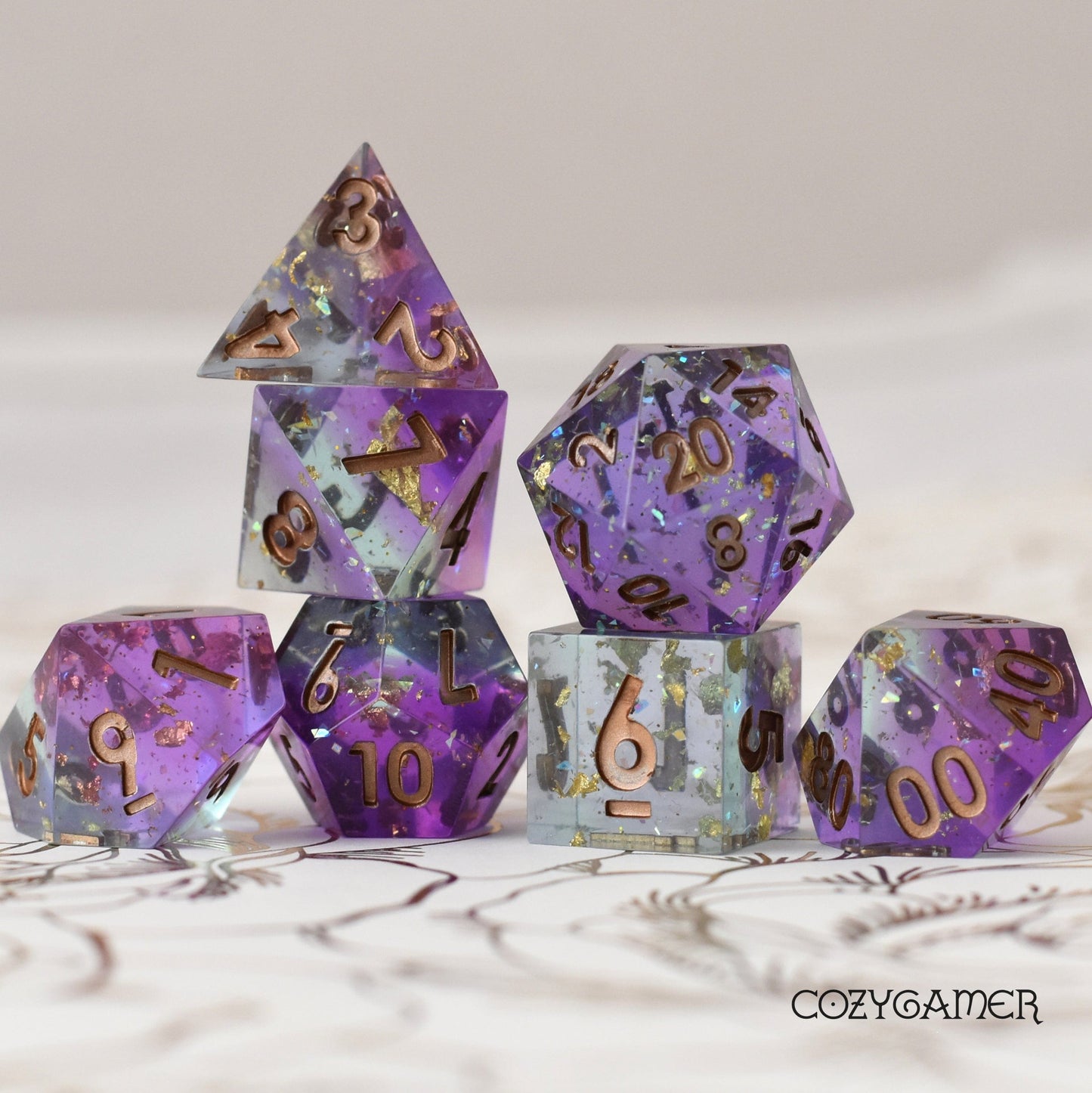 Enchanter's Tower Sharp Edge Dice Set. Layered Purple and Blue Clear resin with copper foil and opal flakes
