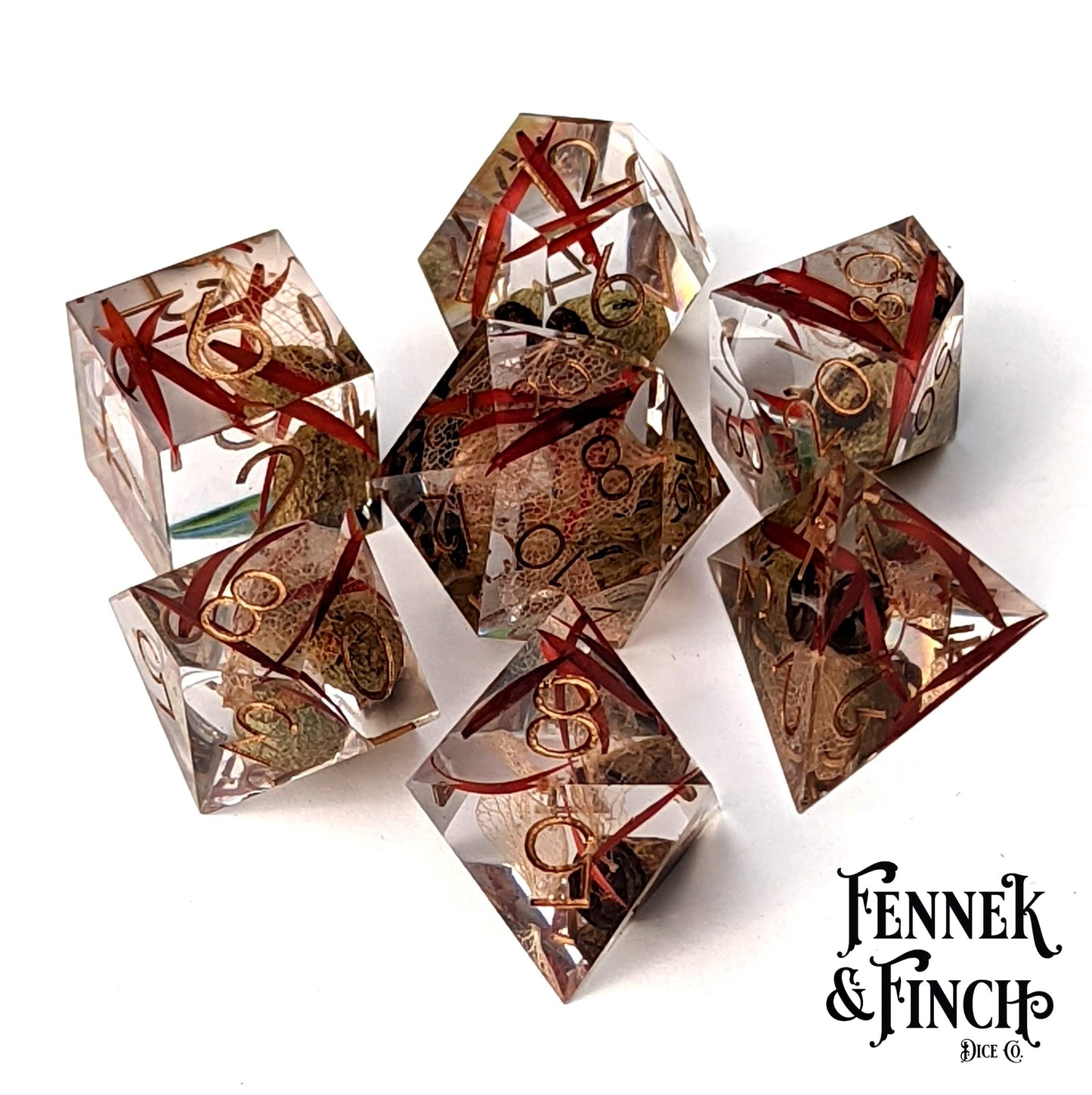 Eucalyptus Sharp Edge Resin Dice Set with dried pods, leaves, and red grass, perfect for TTRPG and DnD players by Fennek and Finch.