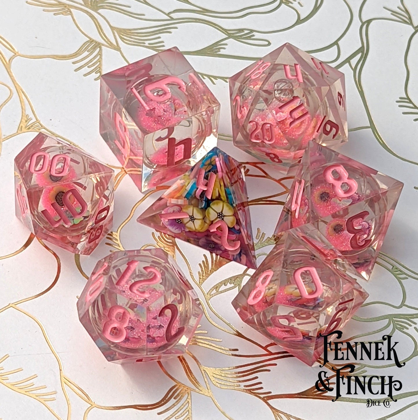 Falling Blossom liquid core DnD dice set with pink glitter and clay flowers, featuring standard 7-piece dice for Dungeons and Dragons.