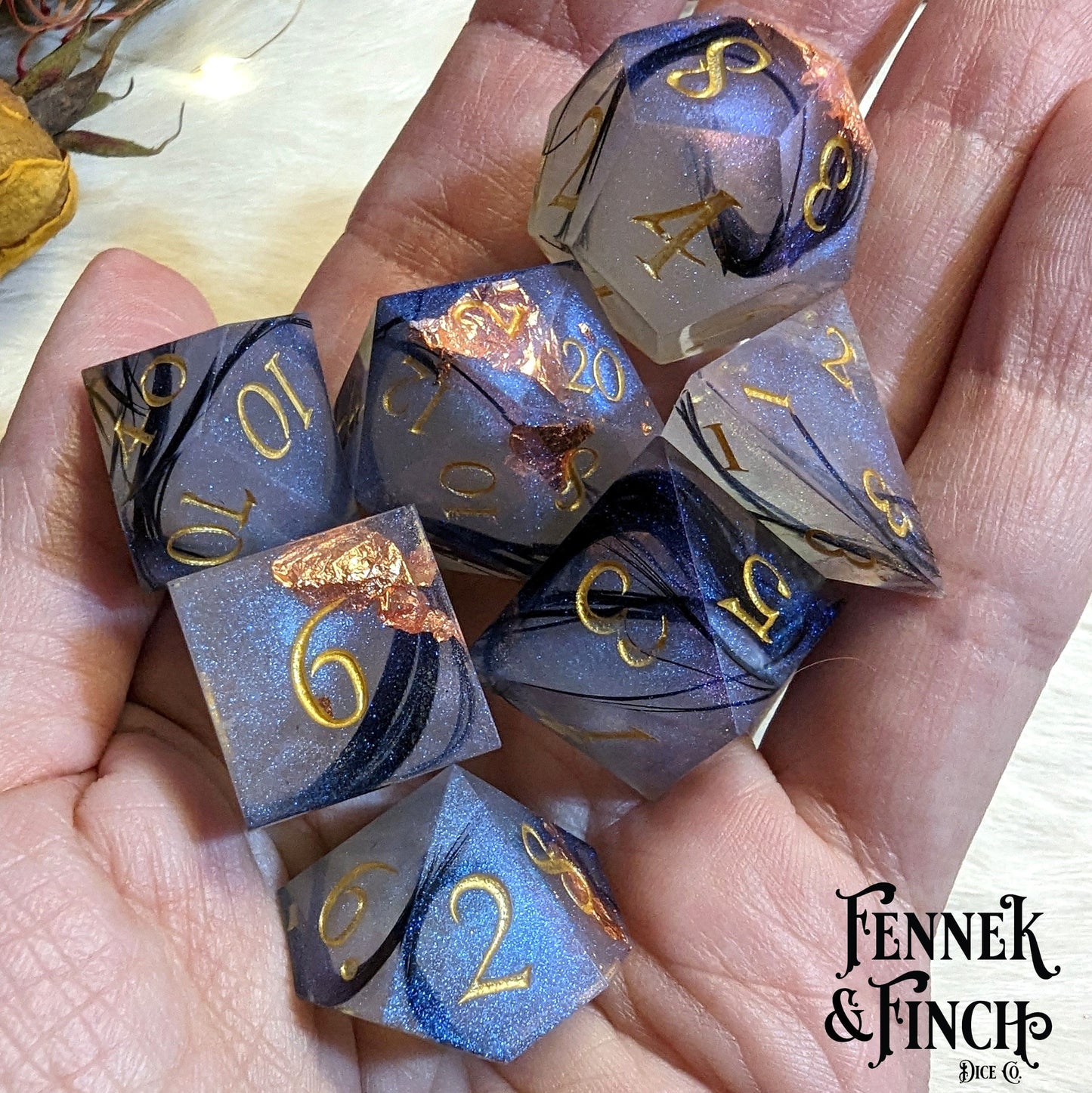 "Feather Fall sharp edge dice set featuring real black feathers, copper foil, and misty effect for DnD and tabletop games."