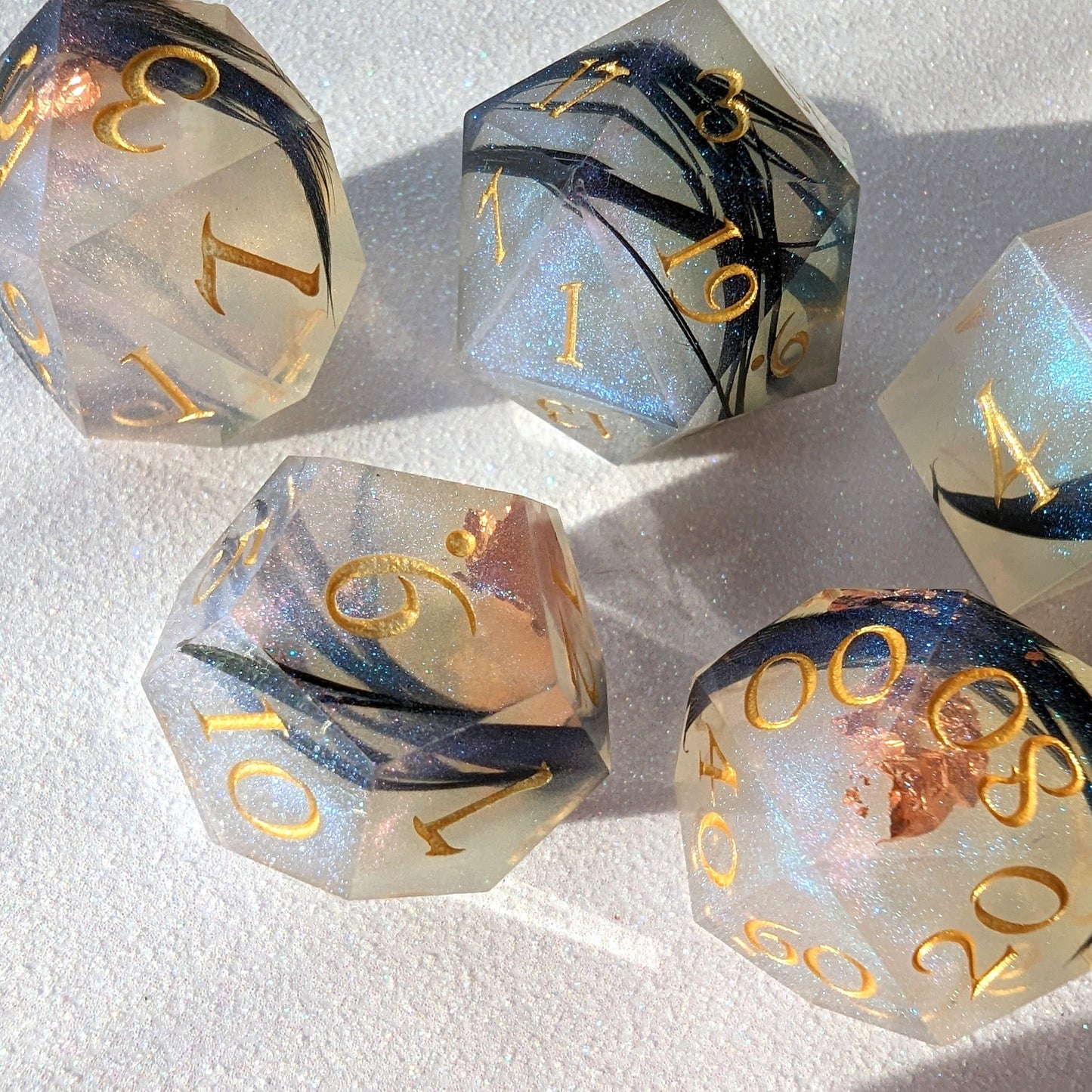 Feather Fall DnD dice set with real black feathers, copper foil, and magical misty effect for tabletop games and Magic the Gathering.