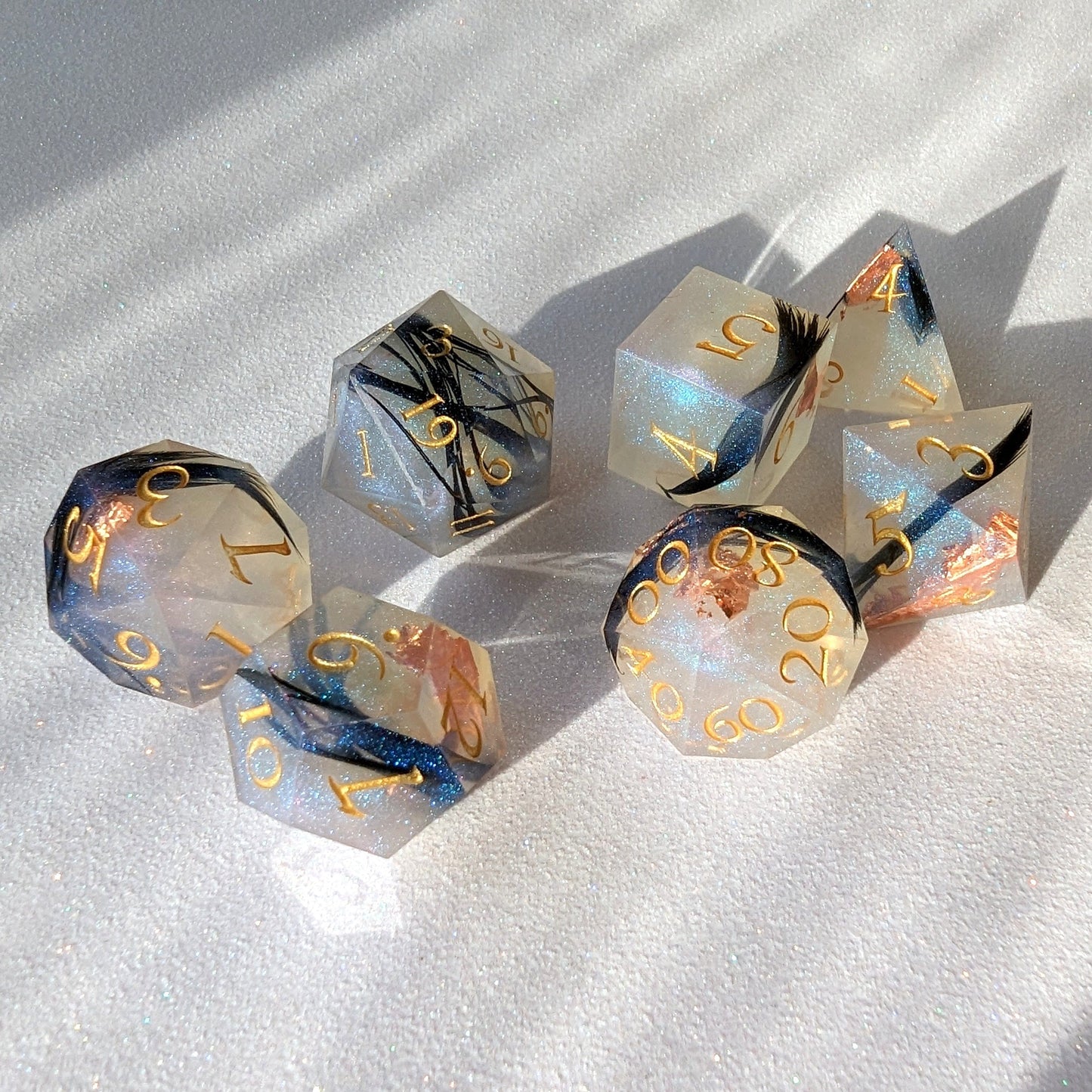 Feather Fall sharp edge DnD dice set with real black feathers, copper foil, and misty effect for tabletop games like Dungeons and Dragons.