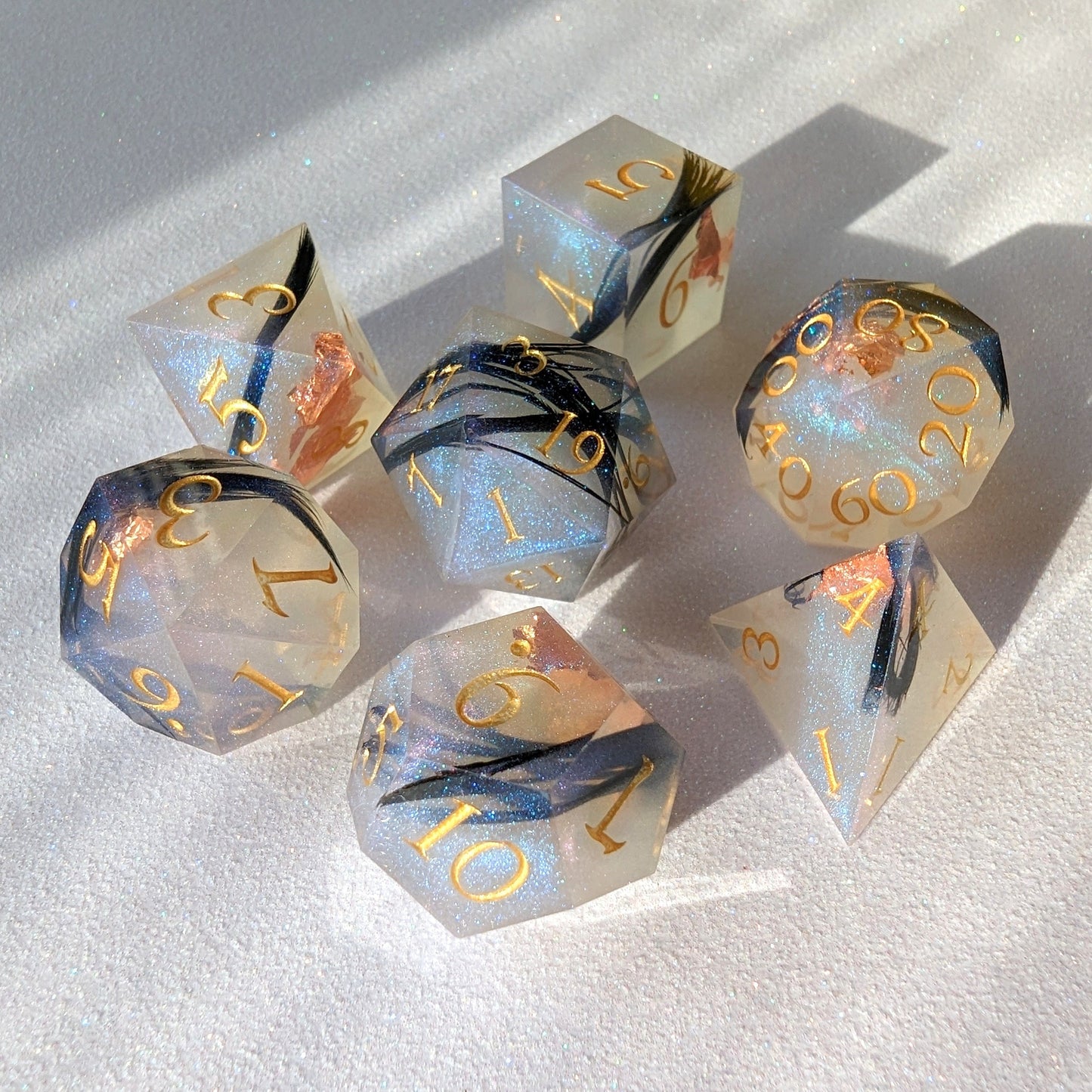 Feather Fall sharp edge dice set with real black feathers and copper foil, perfect for DnD and Magic the Gathering games.