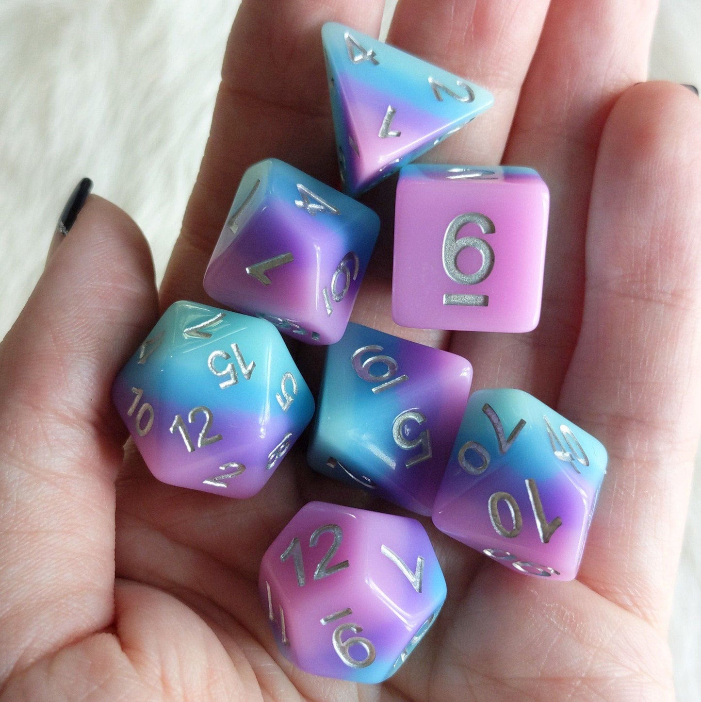 Fey Bloom Dice Set with pink, purple, and blue layers featuring silver numbers for tabletop RPGs like Dungeons & Dragons.