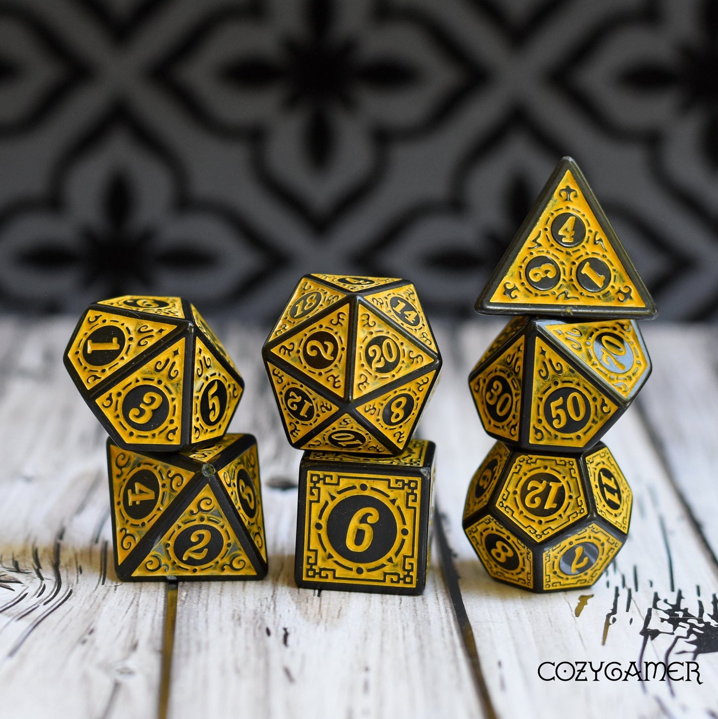 Elegant yellow and black filigree framed polyhedral dice set for tabletop RPGs and Magic The Gathering.