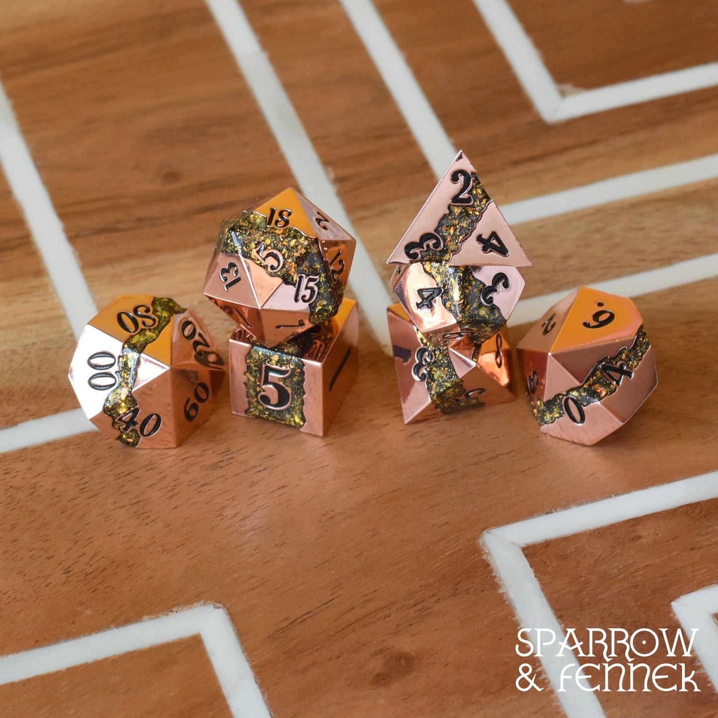 Polyhedral Fissure Metal Dice Set with Copper and Green Gold Glitter, for RPGs like Dungeons & Dragons, on wooden surface.
