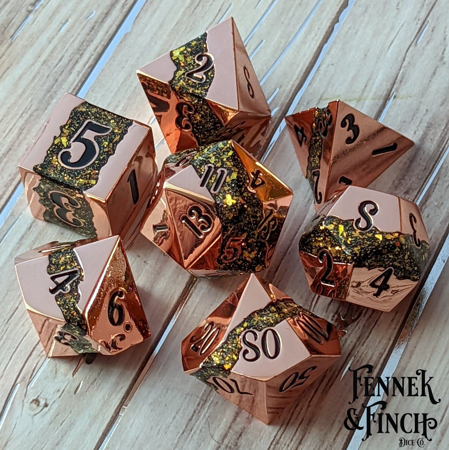 Fissure metal dice set with copper finish and green gold glitter stripe for tabletop RPGs like Dungeons and Dragons.