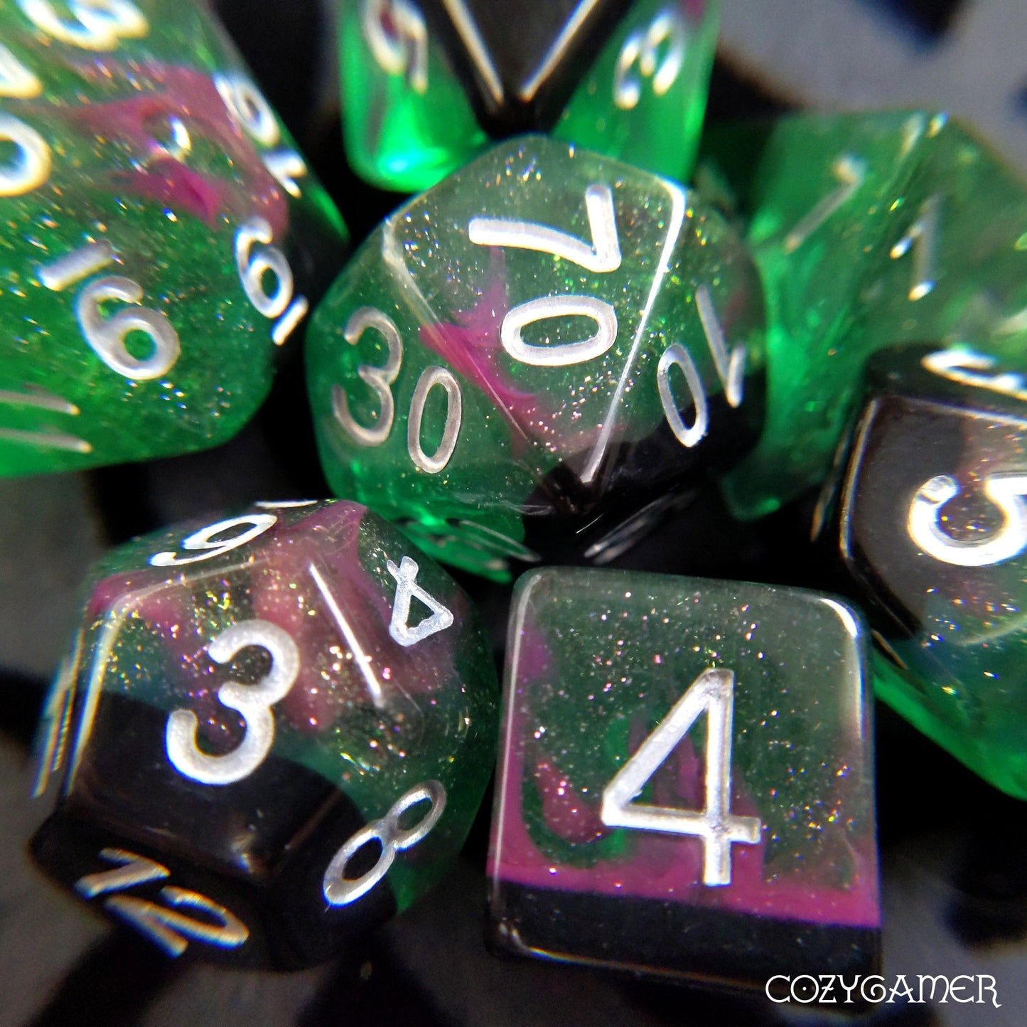 Forest Lights Dice Set in clear green resin with glitter and pink accents for tabletop RPGs like Dungeons and Dragons.