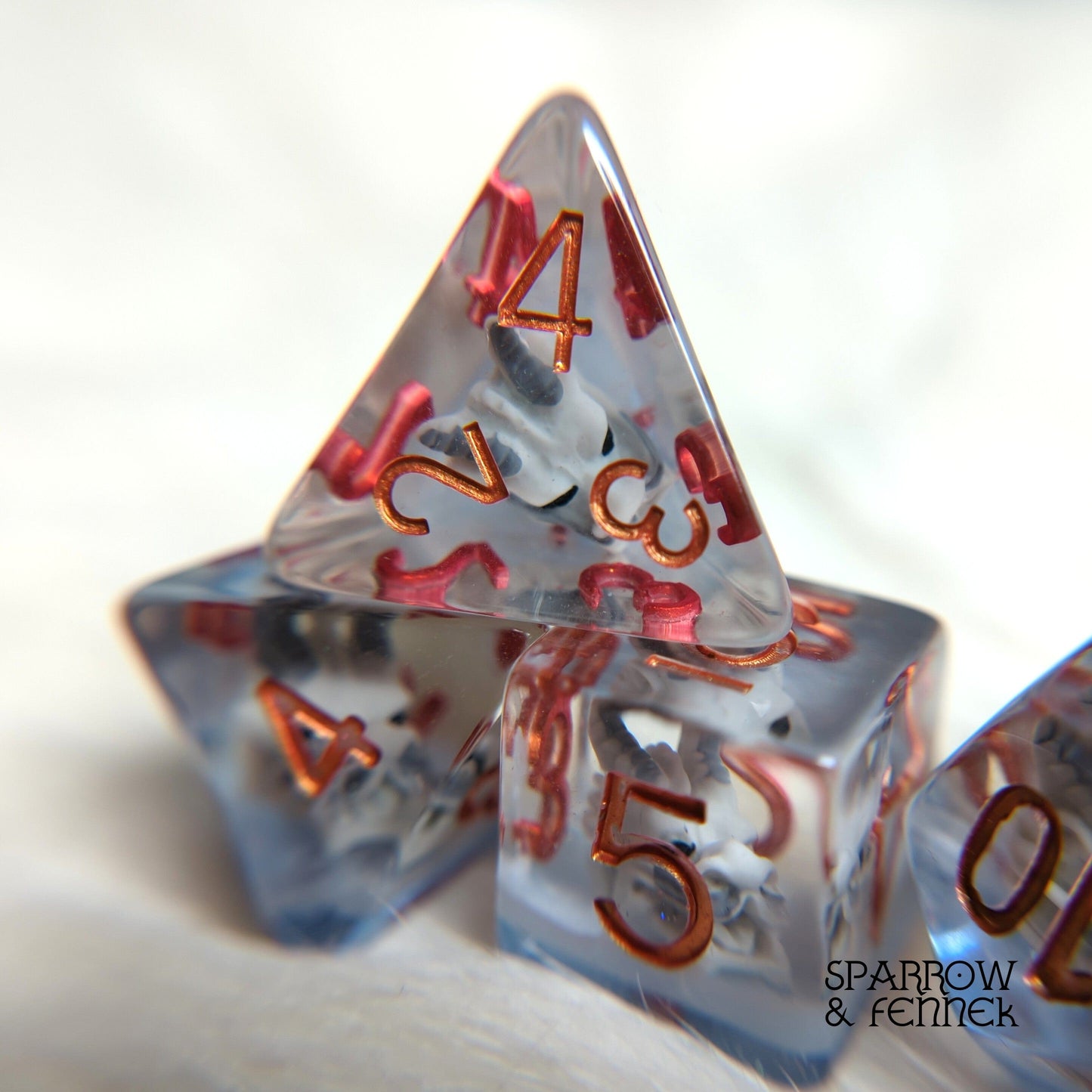Frost Dragon translucent dice set with dragon skull for tabletop RPGs like Dungeons and Dragons, 7 polyhedral dice.