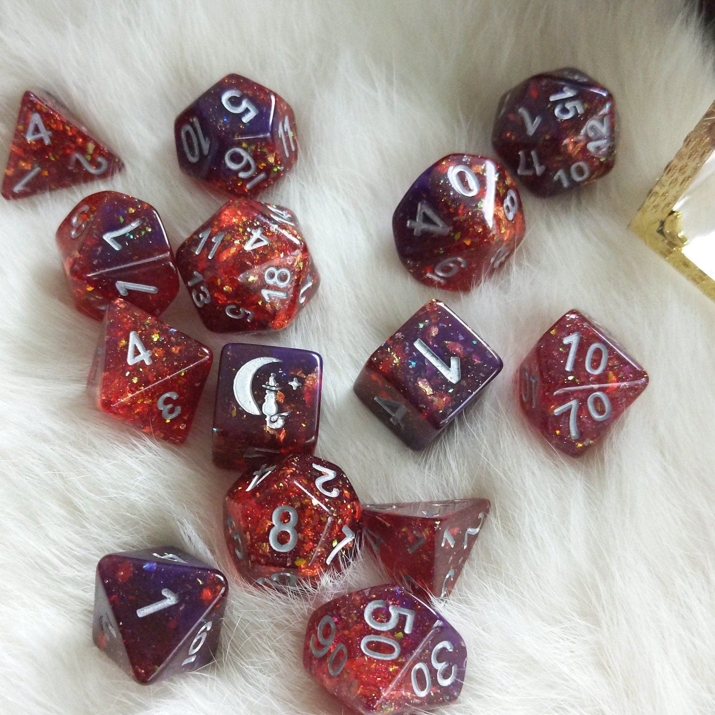 Gambit Dice Set with red, purple, opal flakes, and gold foil for Dungeons and Dragons on white background.