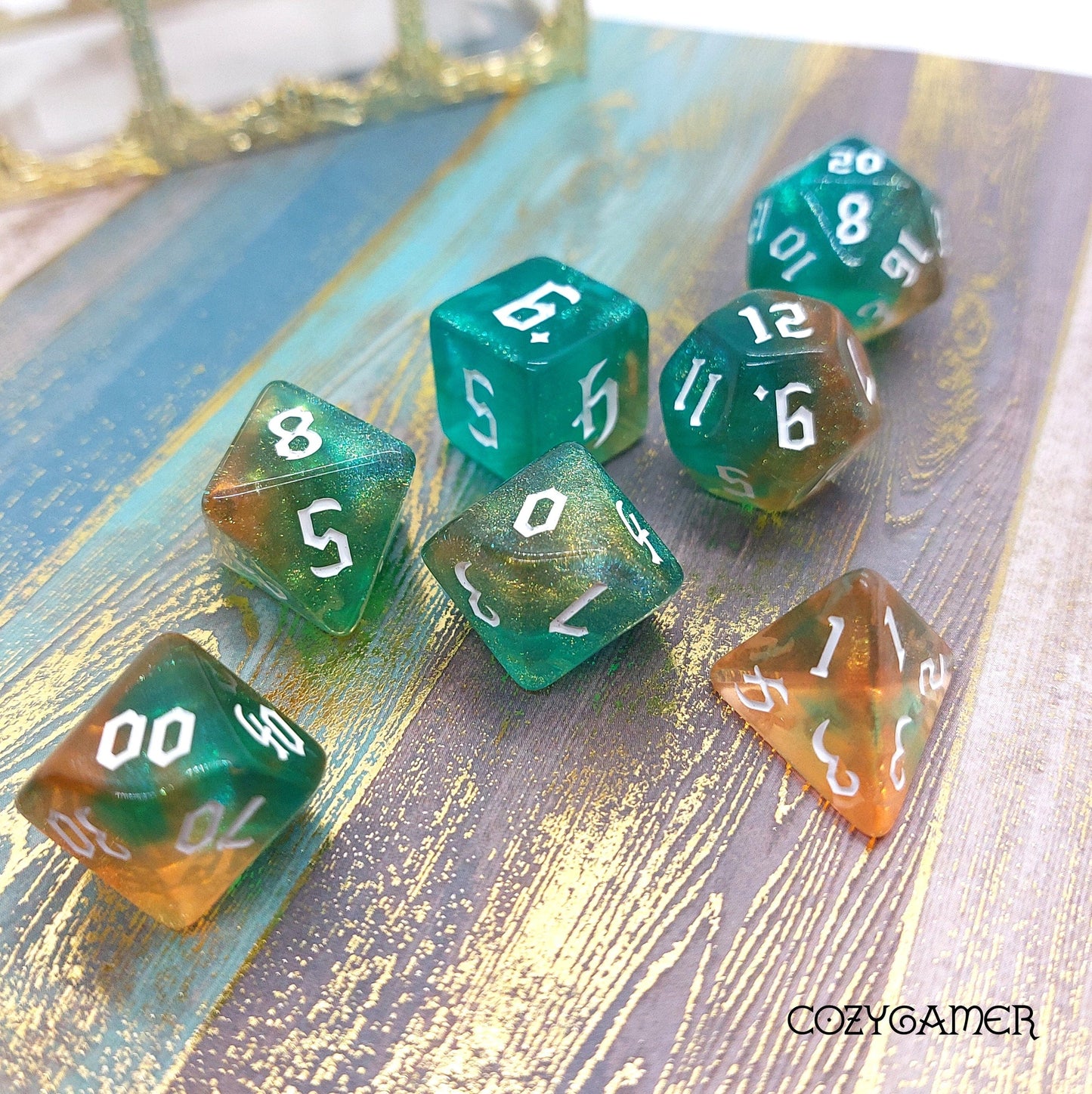 Marbled blue and orange 7-piece polyhedral dice set for tabletop RPGs like Dungeons and Dragons, featuring D20, D12, D10, D%, D8, D6, D4.
