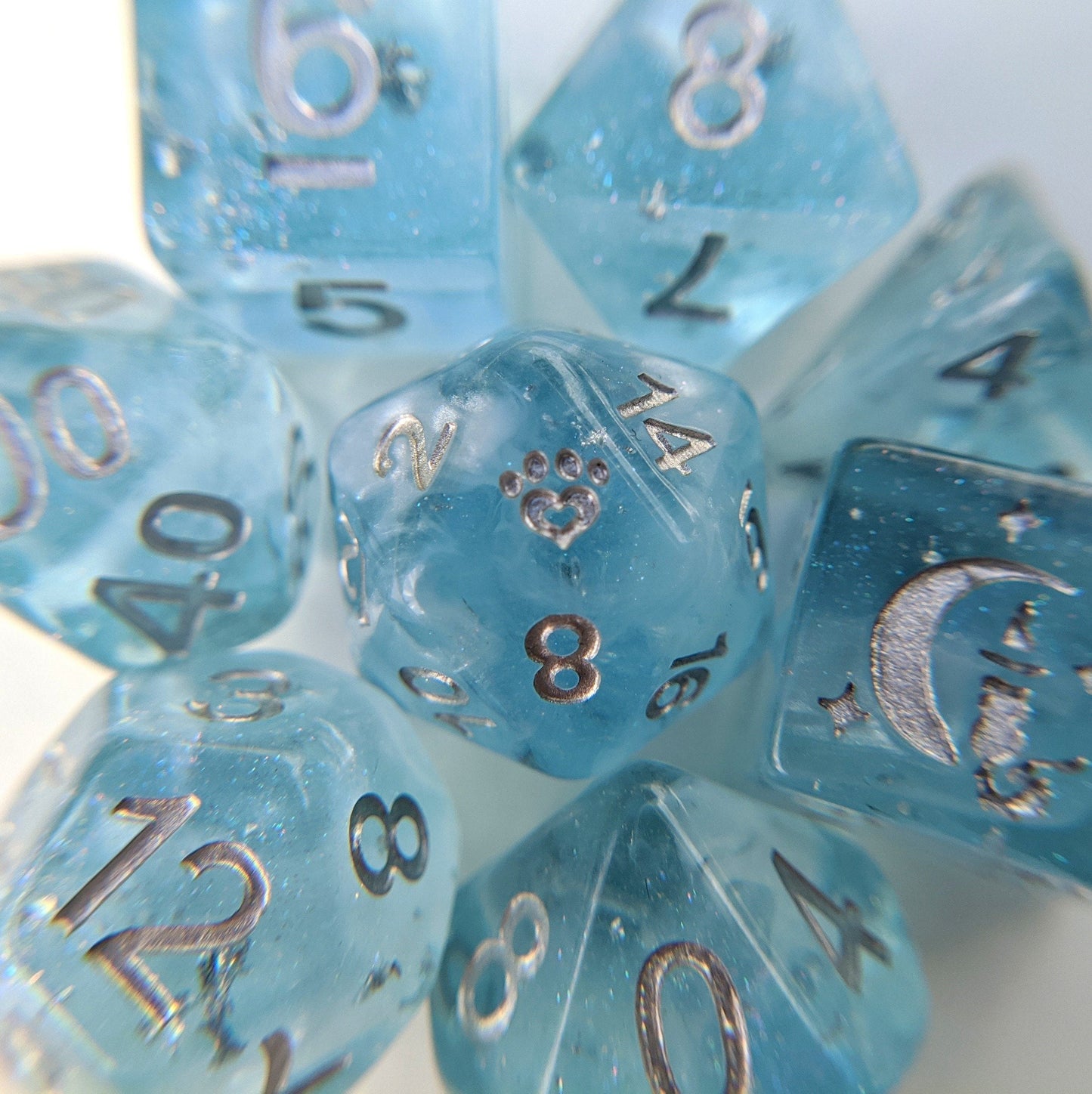Glacial Ice 8 Piece Dice Set. Light clear blue with pearly white clouds and silver foil within. Dice sets Fennek and Finch