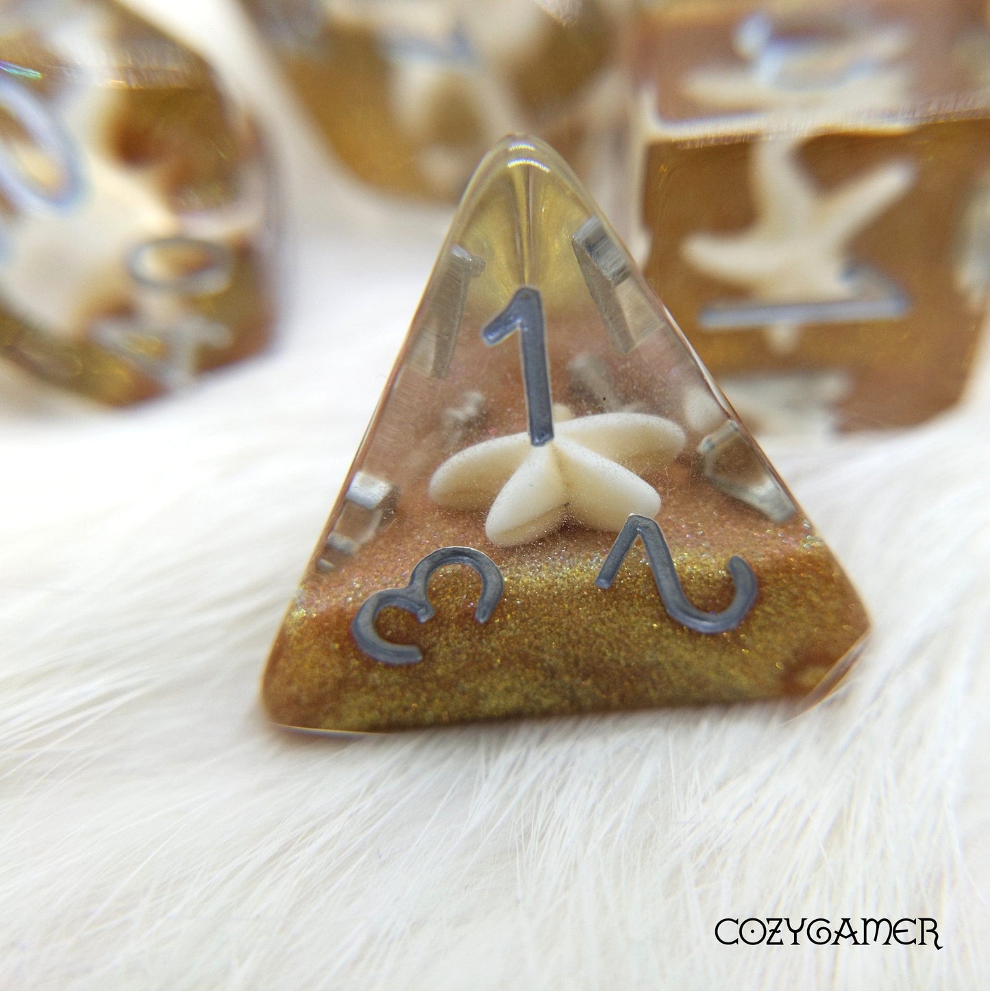 Golden Sands Starfish Dice Set with white starfish on gold glitter, featuring a D4 die for DnD and tabletop role-playing games.