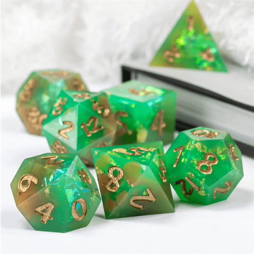 Green and orange sharp edge resin dice set with glitter and gold foil, 7 piece polyhedral TTRPG dice for DND gaming.