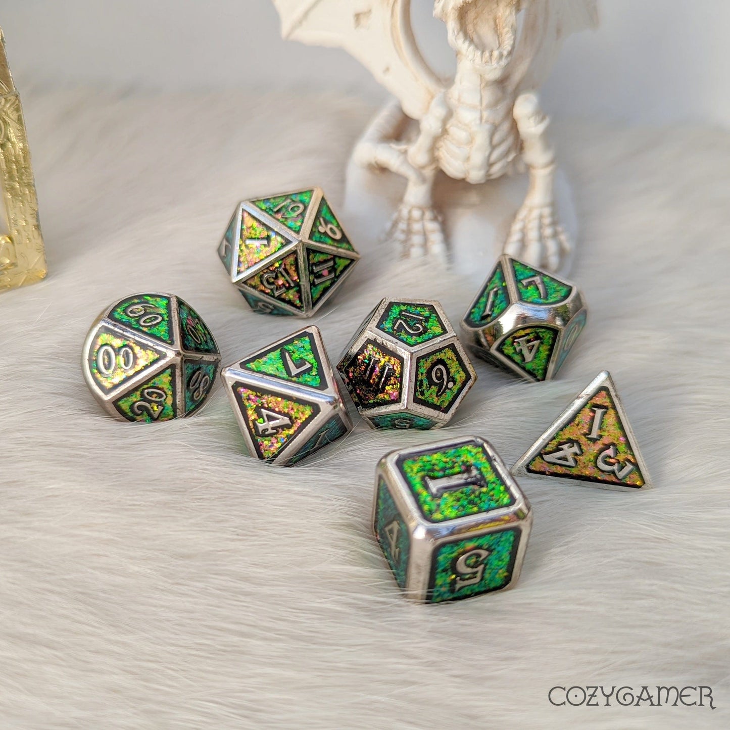 Green and pink color shifting glitter metal dice set with silver trim for tabletop RPGs like Dungeons and Dragons.