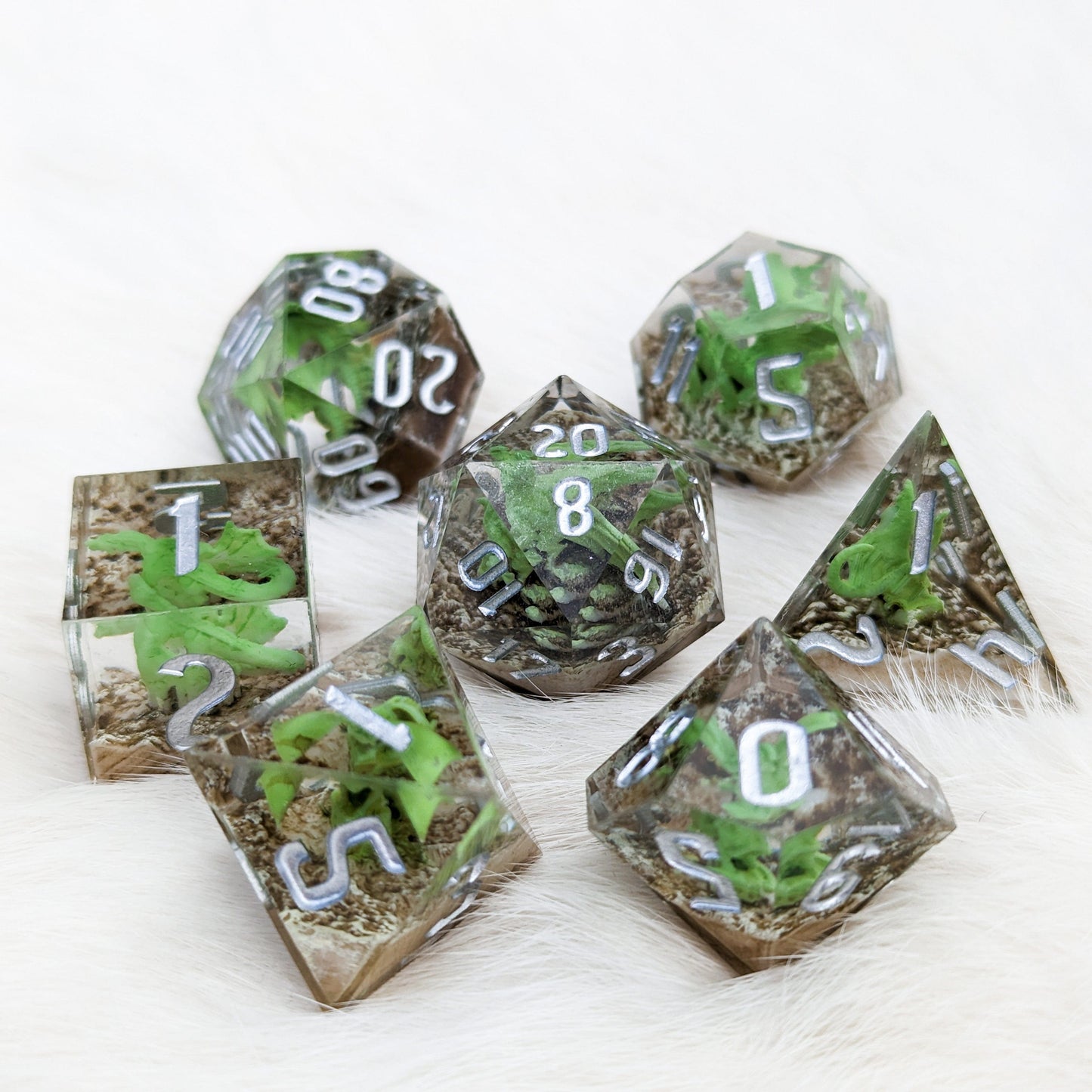 Green Dragon Sharp Edge Resin DnD dice set with miniature dragons, 7 piece polyhedral for tabletop RPG games.