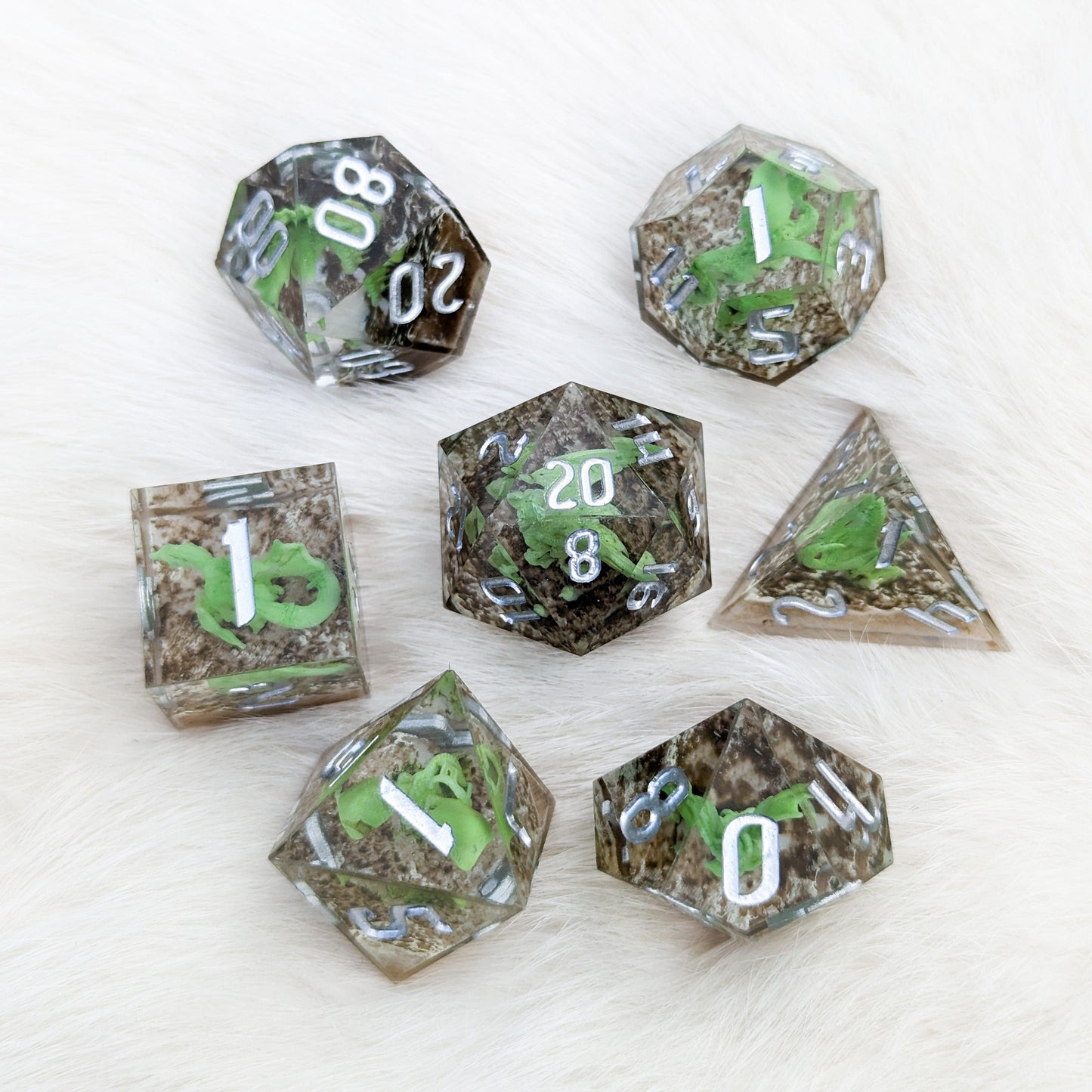 Green Dragon Sharp Edge Resin DnD Dice Set with miniature dragons, 7-piece polyhedral set for tabletop RPG games.