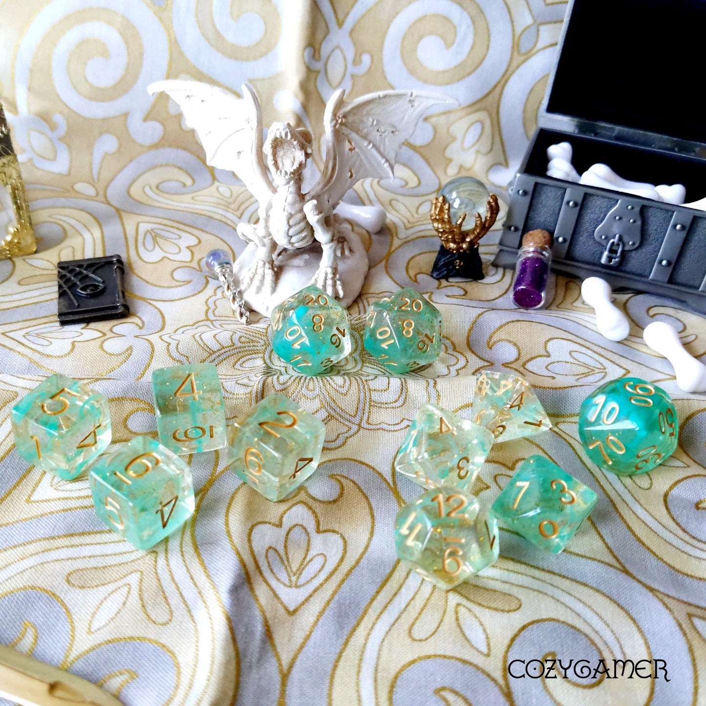 Green Glitter Smoke 11 Piece Dice Set with gold font on Dungeons & Dragons themed table display.