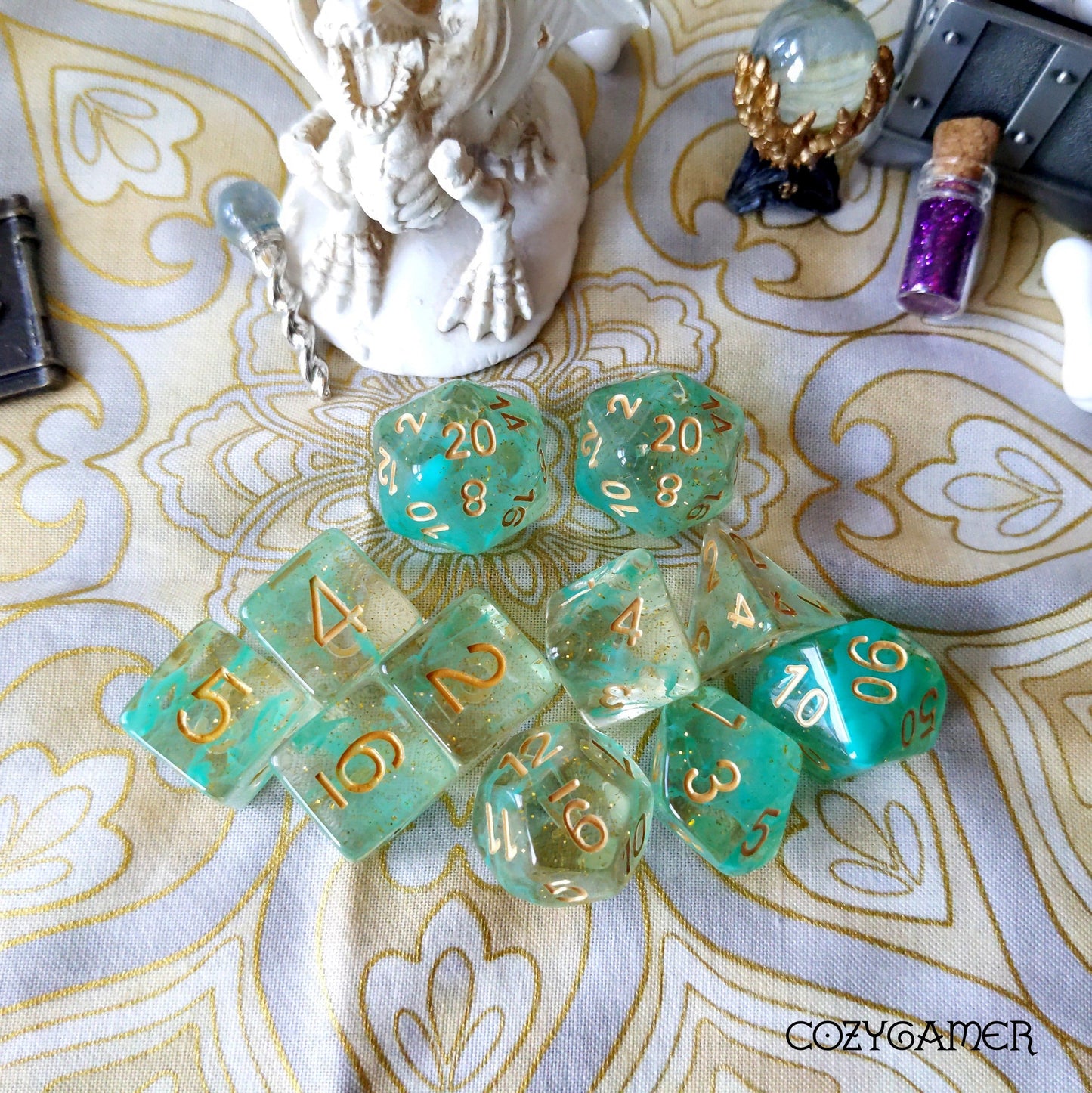 Green Glitter Smoke 11 Piece Dice Set with gold font for Dungeons & Dragons, featuring clear resin with glitter and green smoke effect.