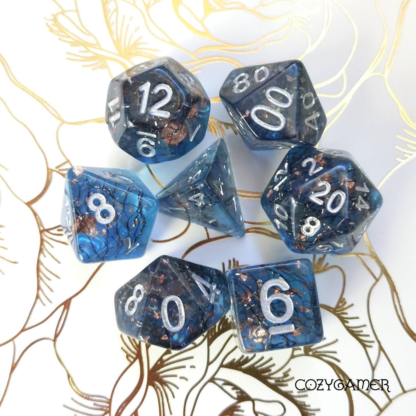Haunted Forest DnD dice set with shimmering brambles and copper foil on floral background, 7 polyhedral pieces for tabletop games.