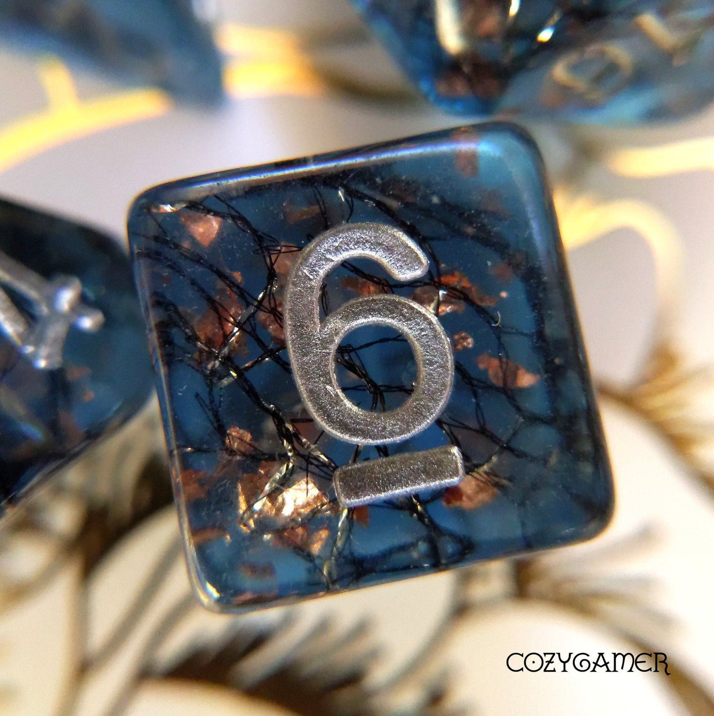 Haunted Forest DnD dice showing the number six with shimmering thread and copper foil, inspired by a dark forest theme.
