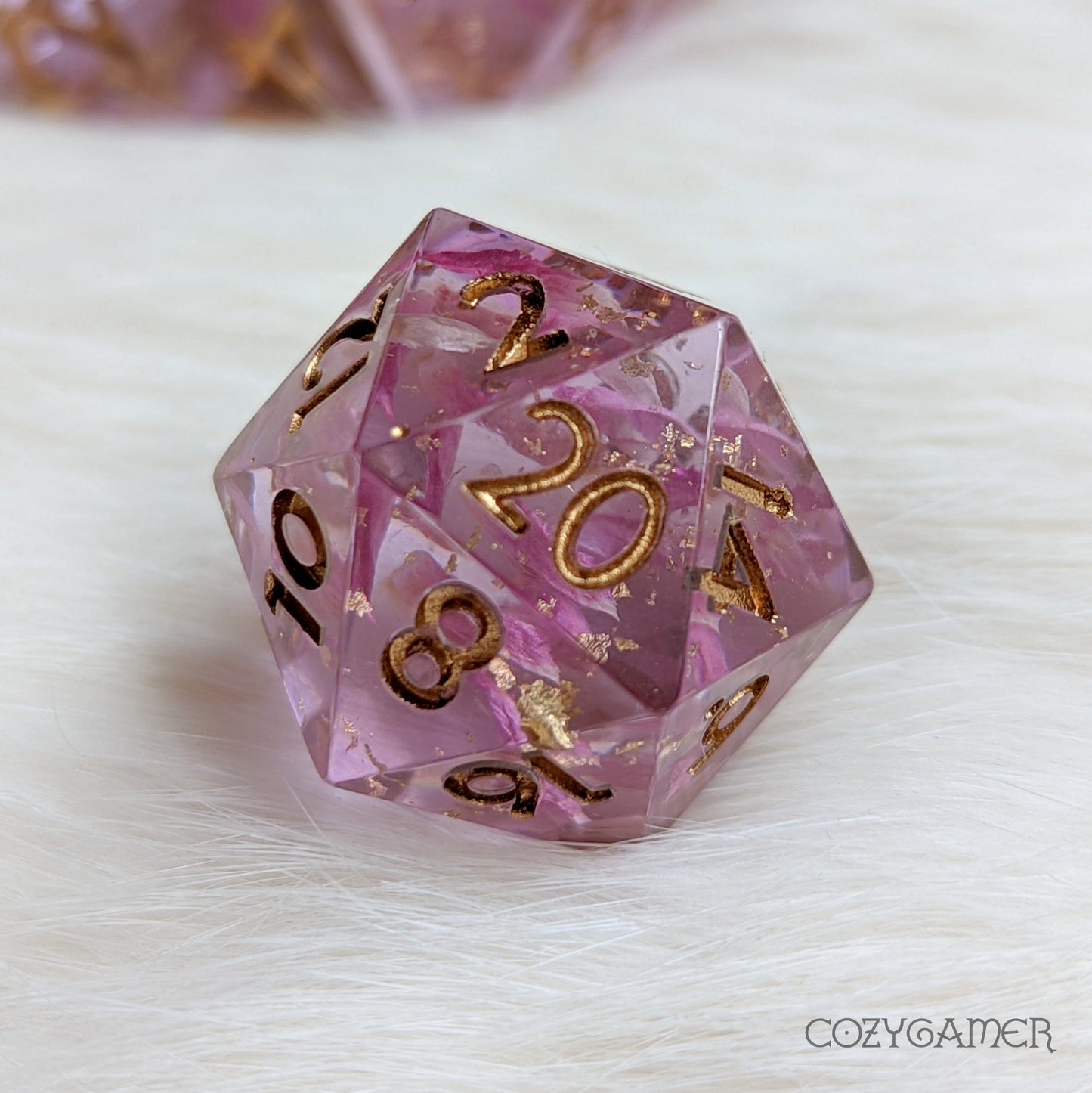 Mauve sharp edge resin D20 dice with petals and gold foil, part of Immortal Love 7 Piece polyhedral TTRPG DND dice set.