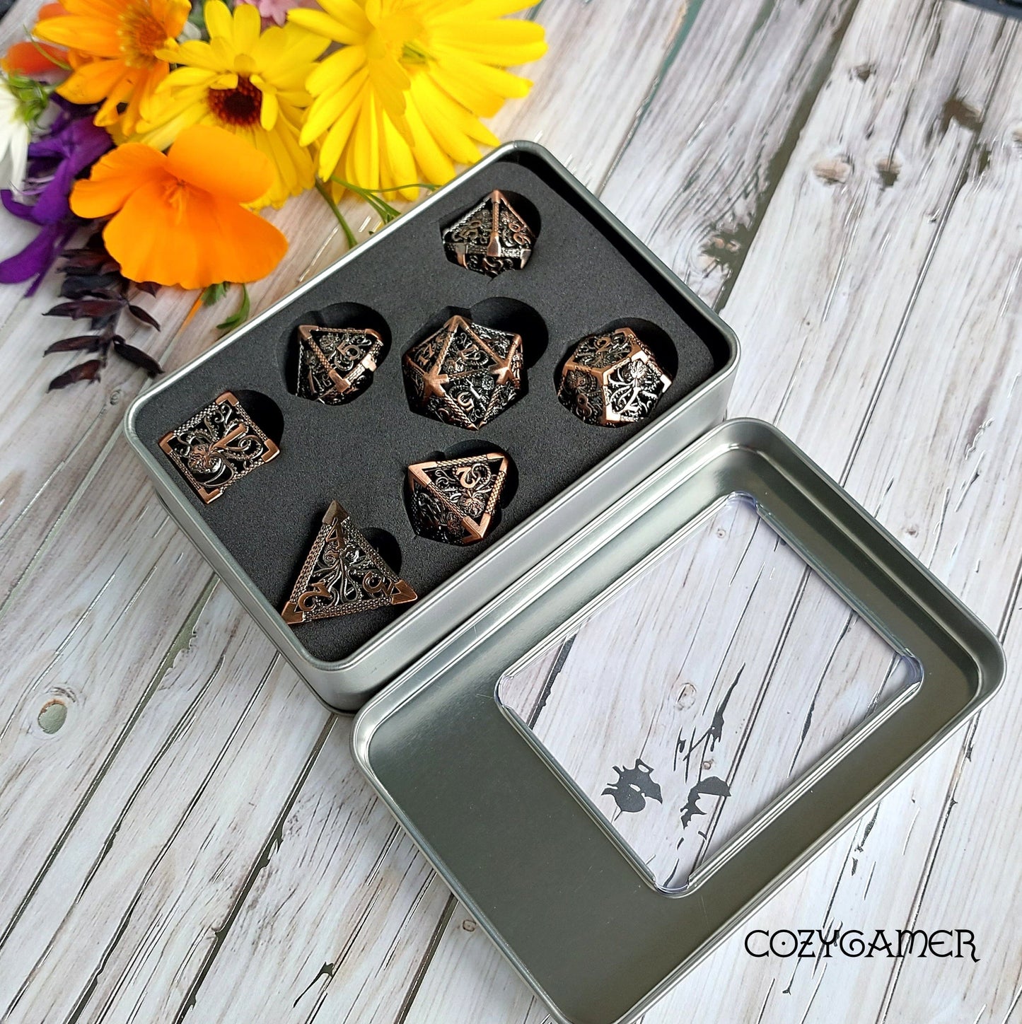 Kraken Hollow Metal Dice Set in tin box with decorative flowers, 7 polyhedral dice for tabletop RPGs like Dungeons and Dragons.