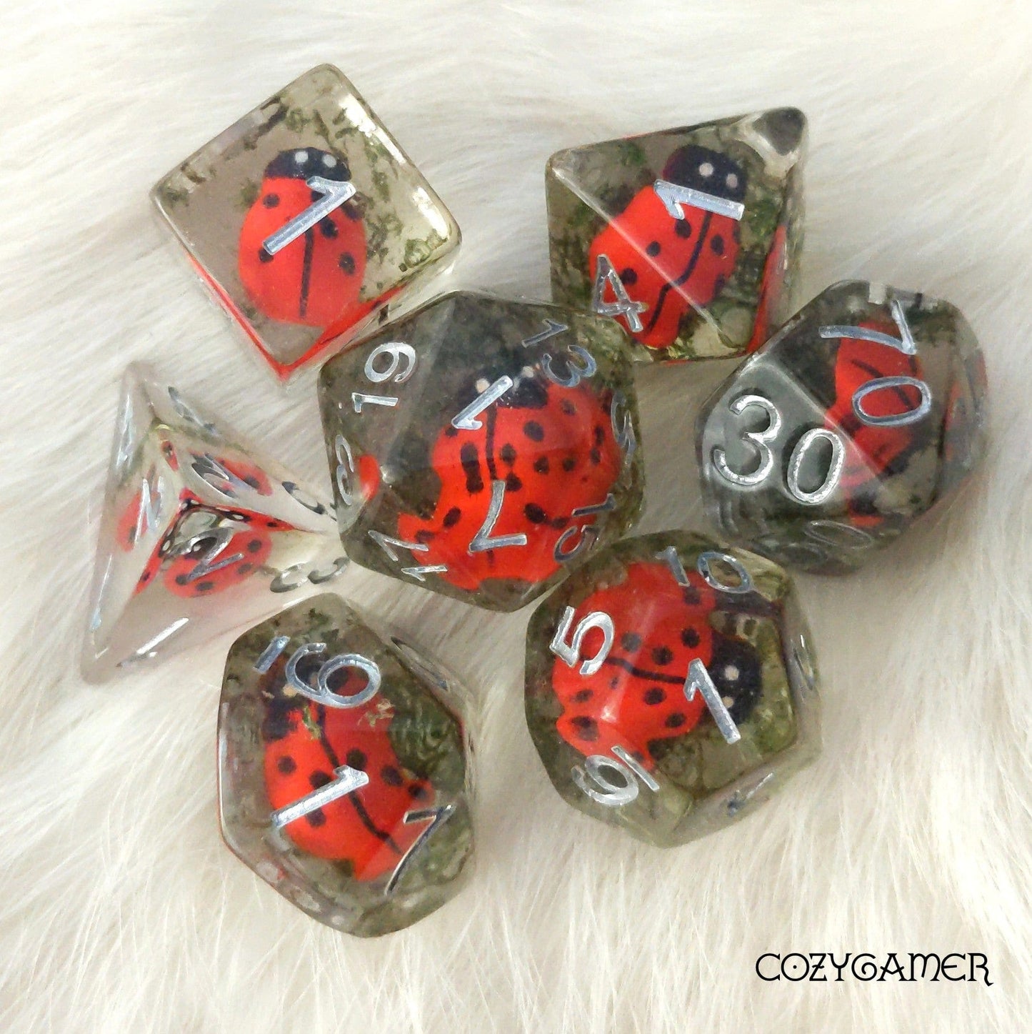 Ladybug dice set with resin insects and moss for tabletop RPGs like Dungeons and Dragons, featuring 7 intricately designed dice.