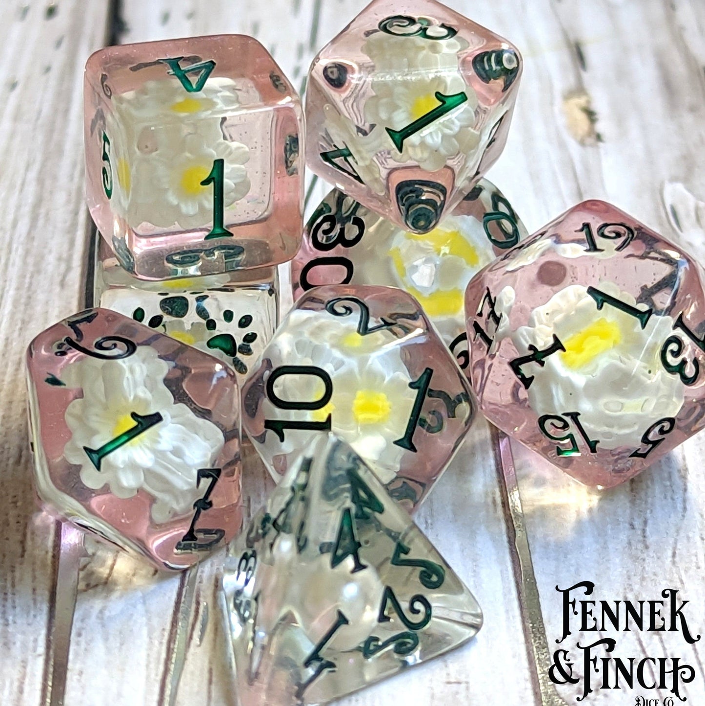 Lily Dice Set with white lilies on pink dice, featuring custom numbers and a D6 with a cat wizard, perfect for tabletop games.