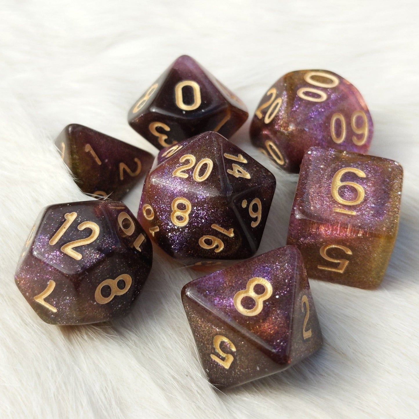 Mimic Dice Set, micro shimmer galaxy dice in purple, yellow, and brown with pale gold font, 7 piece polyhedral set for TTRPGs.