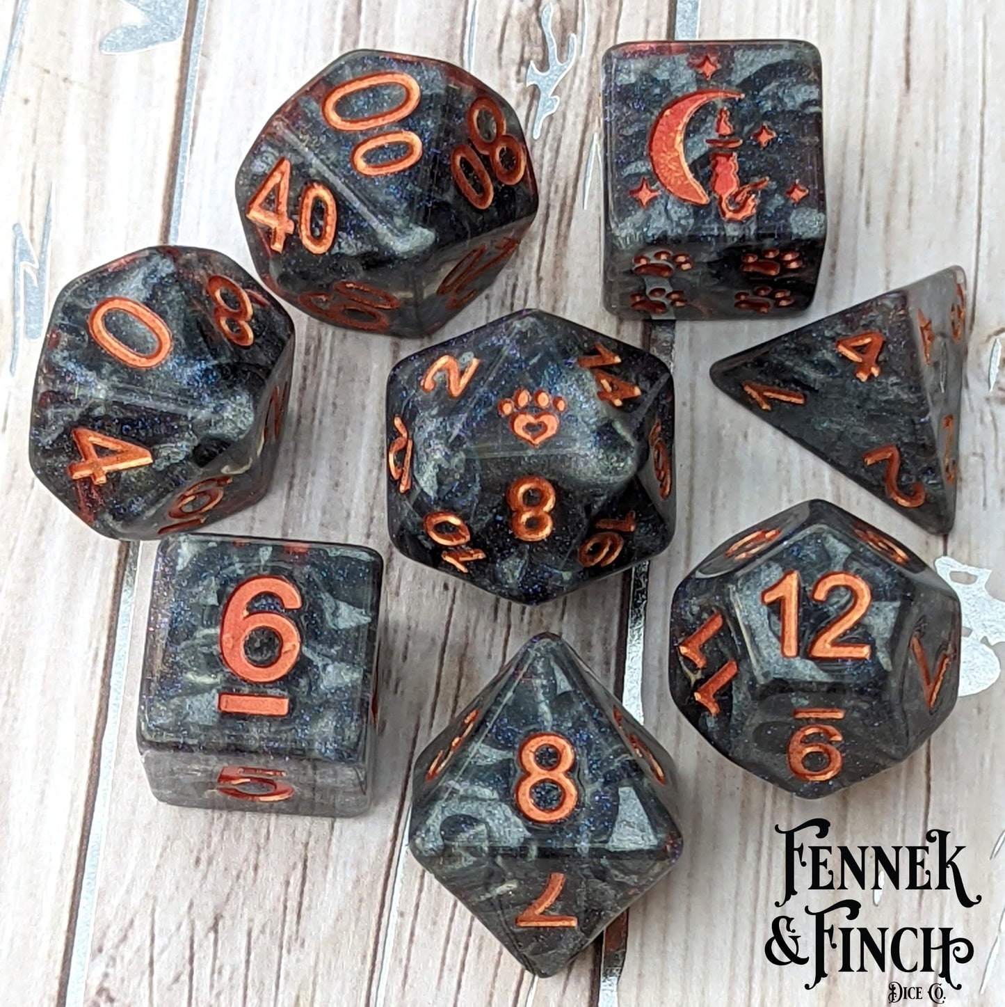 Nimbus 8 piece polyhedral dice set with pearly grey clouds, glitter, and custom cat wizard, featuring orange numbers and paw designs.