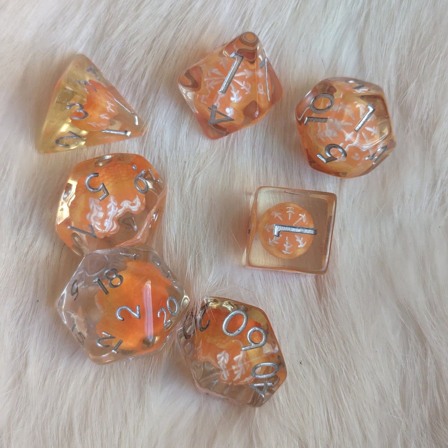 "Peeled Orange resin DND dice set on fur background, 7 piece standard gaming dice for tabletop RPG games"