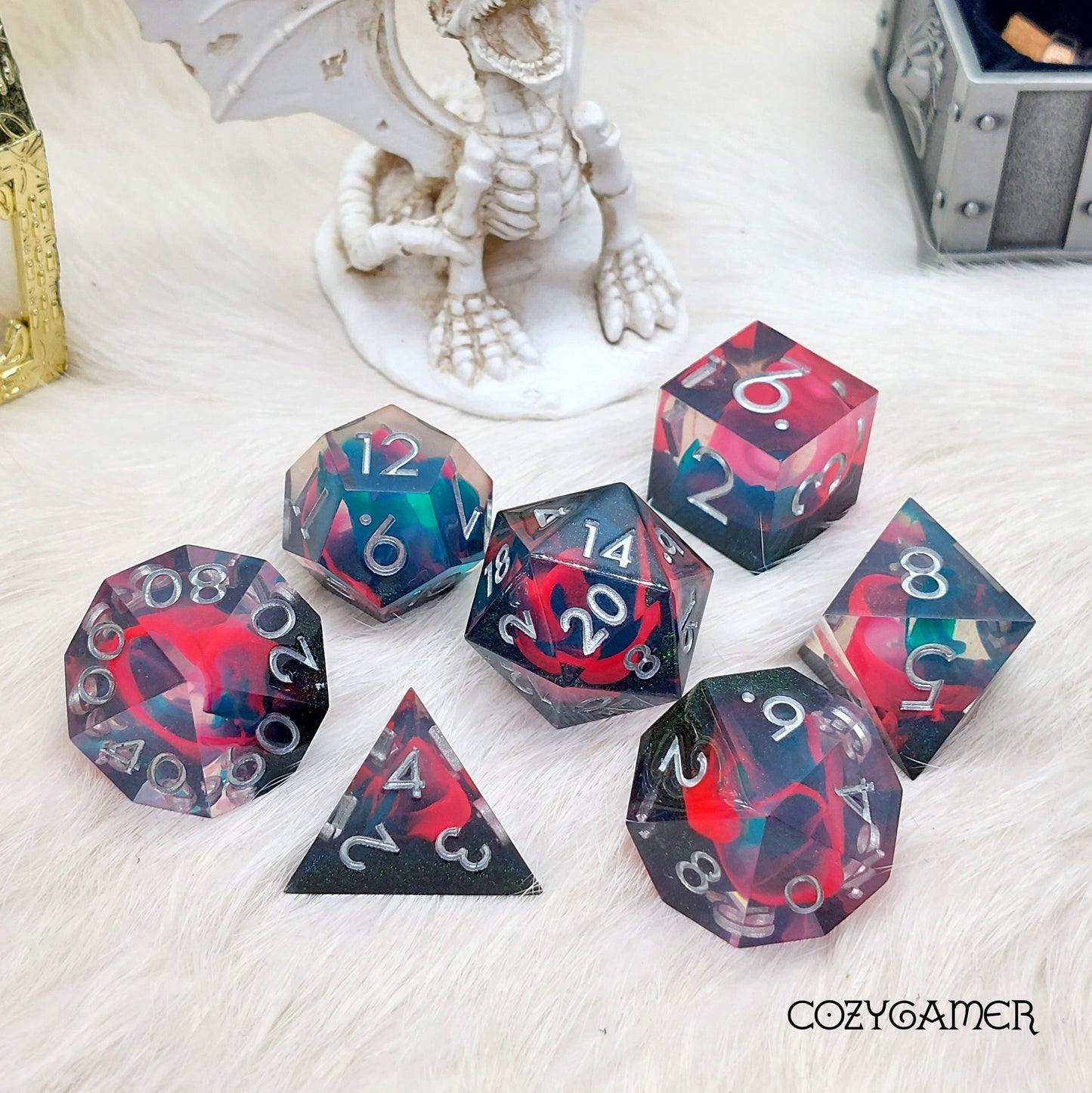 Perfect Weapon sharp edge resin dice set with black, pink, and blue flame design for DND TTRPG. 7-piece polyhedral dice.