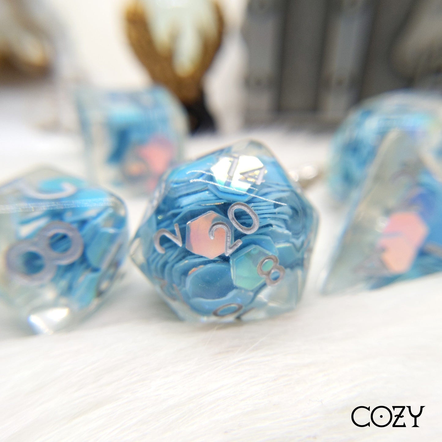 Periwinkle Glint Dice Set with hexagonal blue rainbow glitter in clear resin, perfect for Dungeons and Dragons, tabletop gaming essentials.
