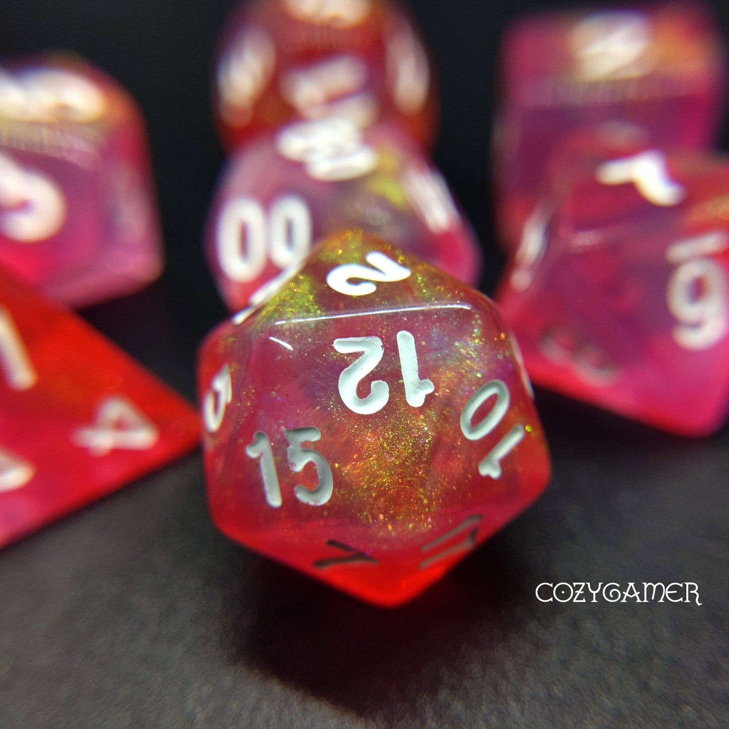 Pink Bunny Will O Wisp glitter polyhedral dice set for TTRPG, featuring shimmering pink and red acrylic D20, D12, D10, D%, D8, D6, D4.