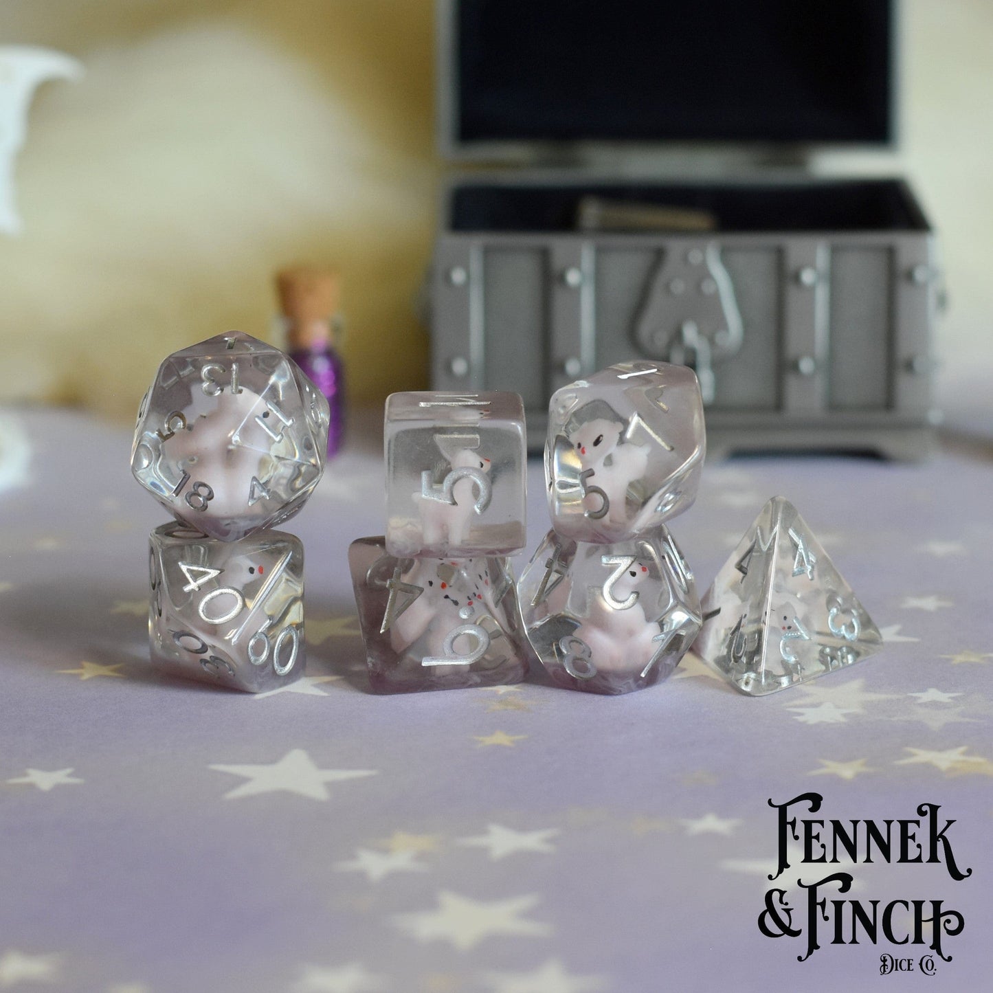 Pink Llama Dice Set with purple resin and llamas, 7-piece polyhedral for Dungeons and Dragons, displayed on star-patterned surface.