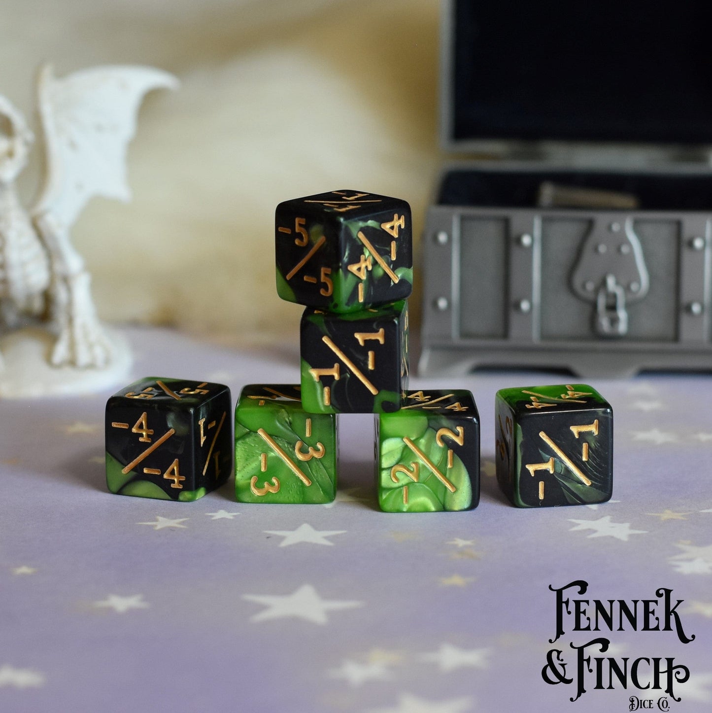 Set of 6 pearly green and black acrylic negative D6 counter dice stacked on a table, featuring Fennek & Finch branding.