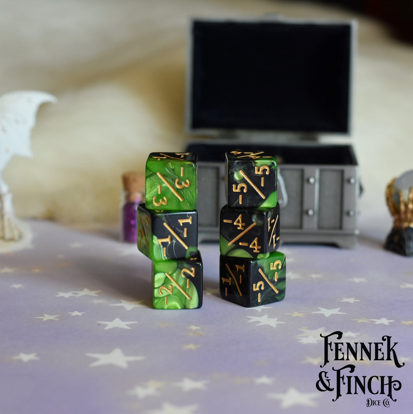Set of 6 pearly green and black acrylic negative D6 counter dice on a mystical tabletop with Fennek & Finch logo.