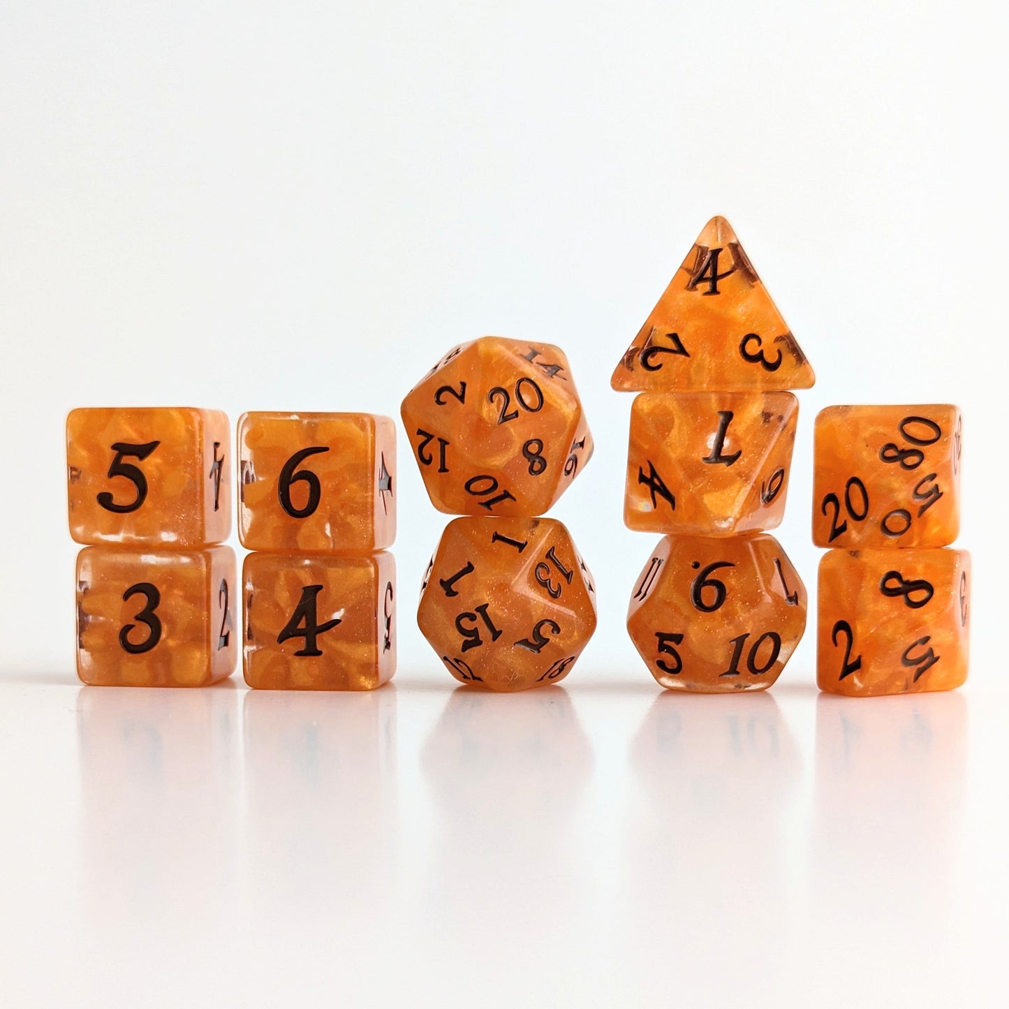 Pumpkin Pie orange DnD dice set with 7 and 11 pieces, perfect for adding a cozy autumn vibe to your tabletop gaming adventures.