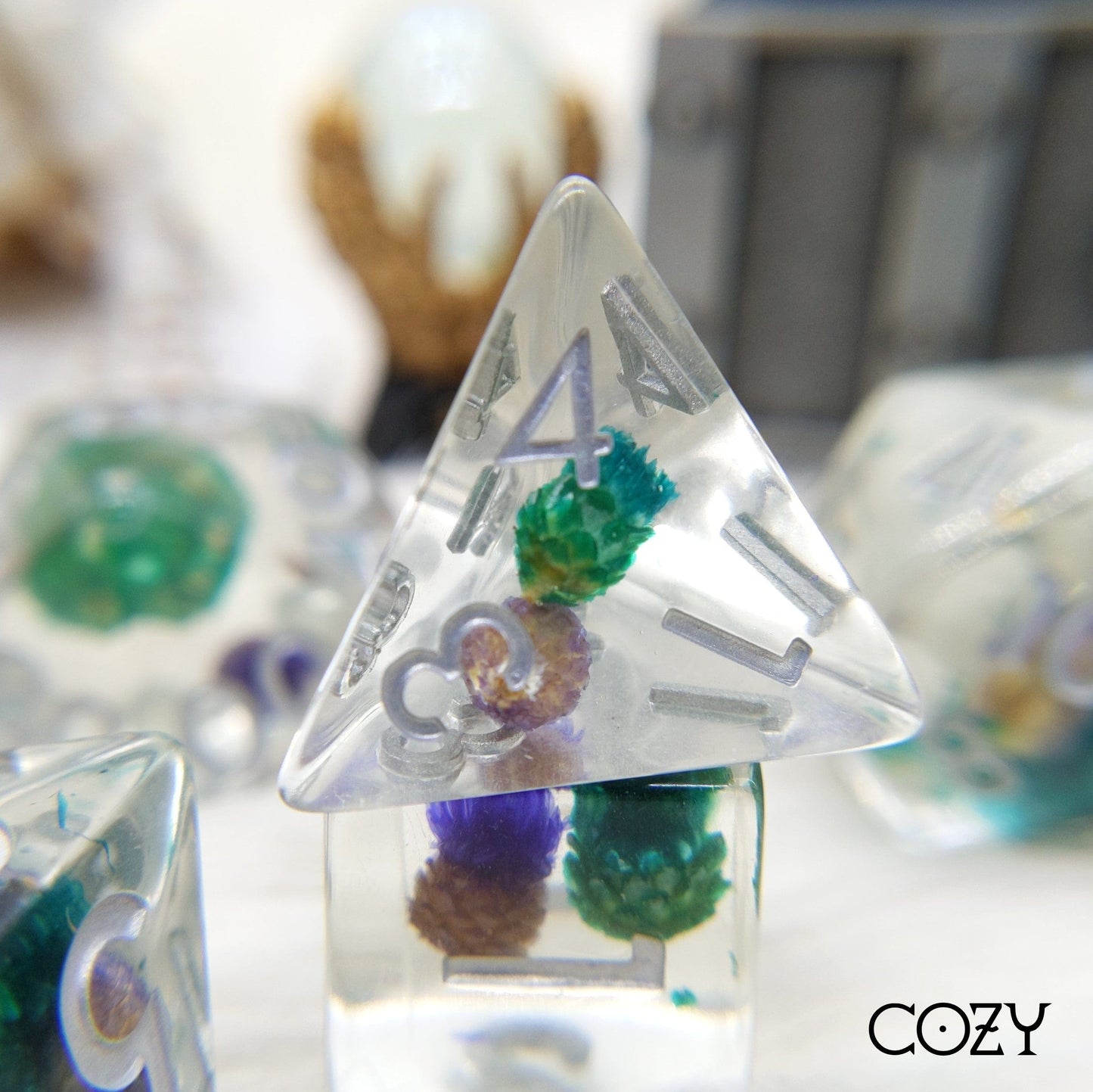 Clear resin dice set with real dried purple and blue flowers for tabletop RPGs like Dungeons and Dragons.